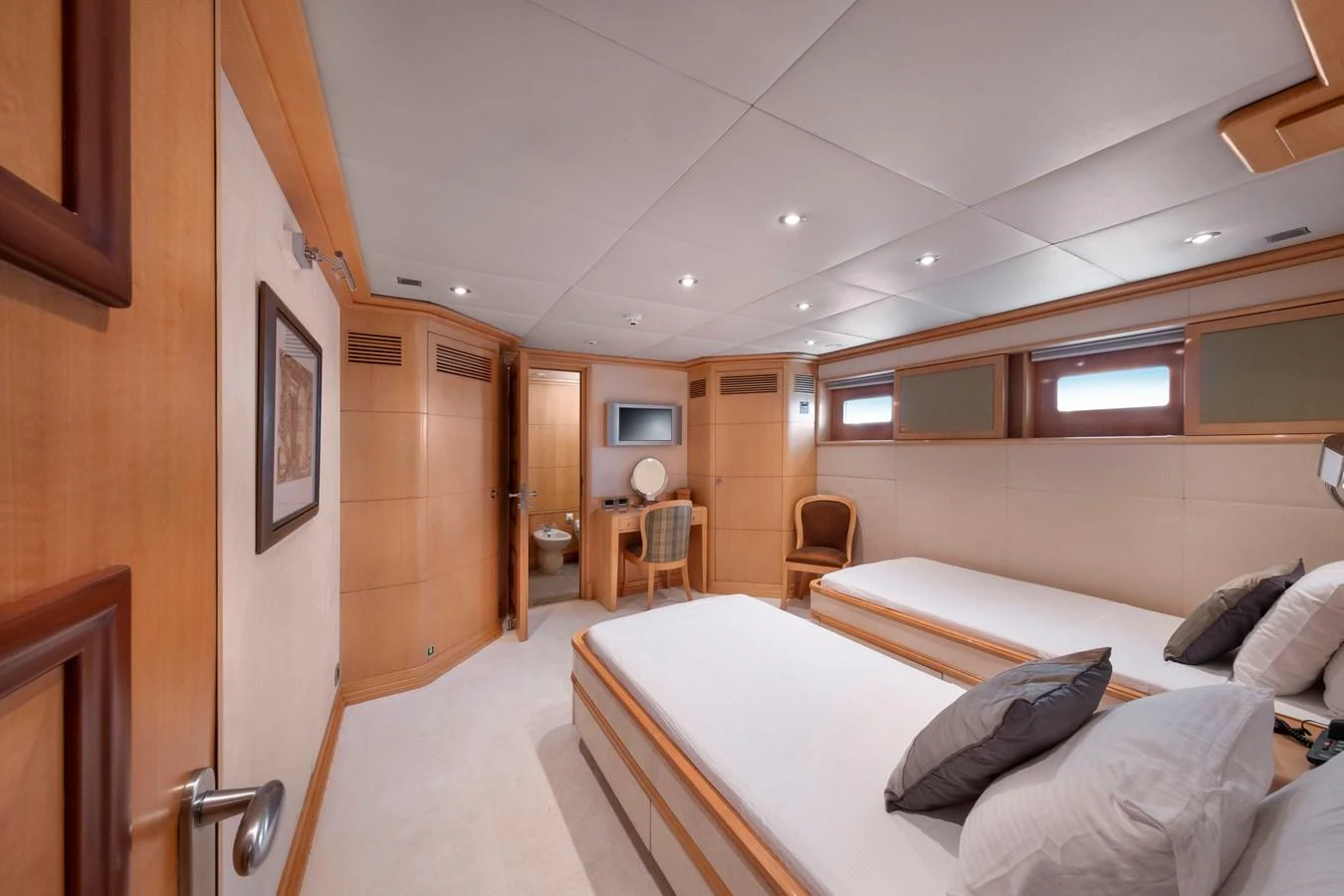 The guest stateroom features twin beds and a private ensuite, offering a cozy and inviting atmosphere. aboard HAPPY DOLPHIN II Yacht for Sale