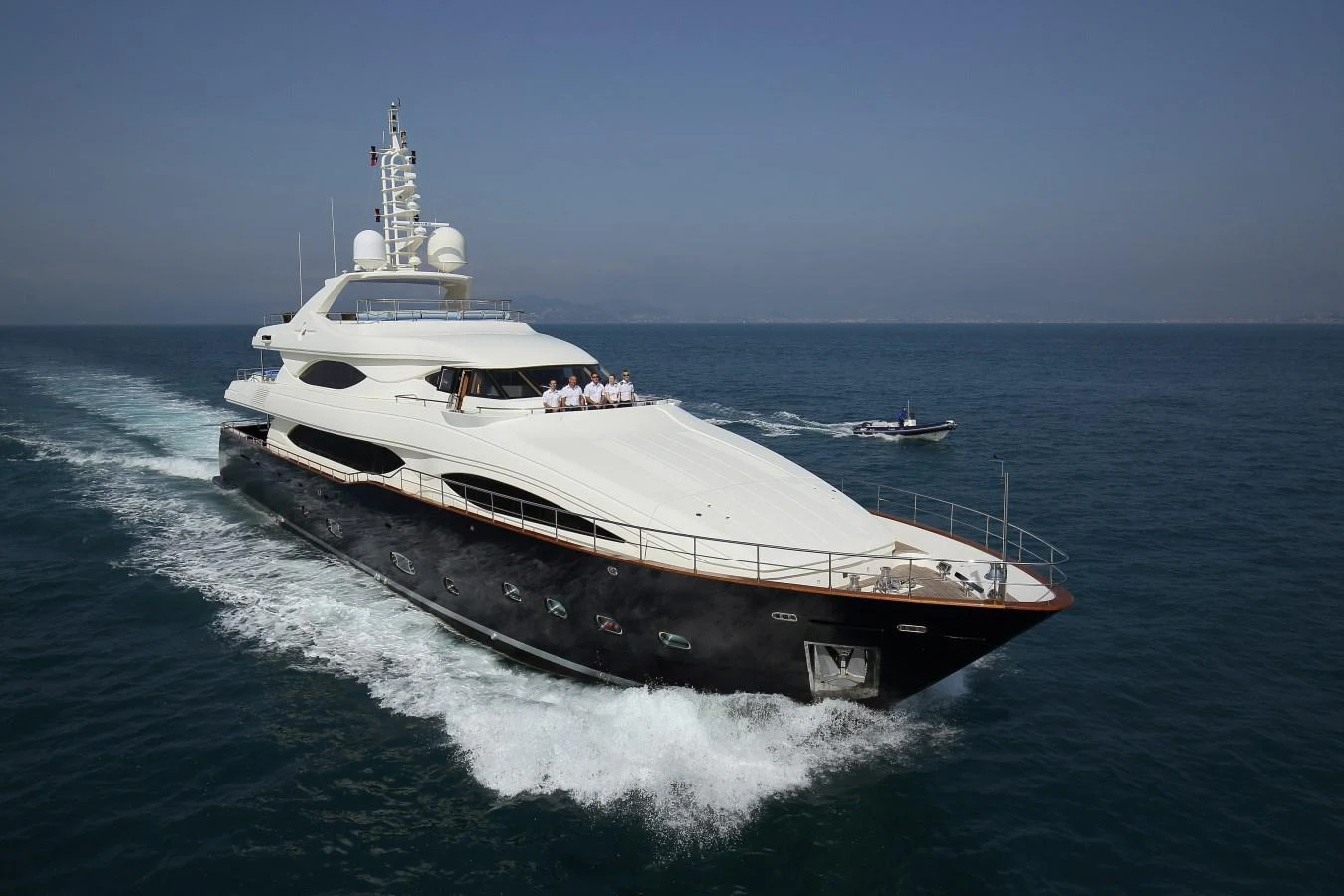 A sleek and luxurious yacht cruises through calm waters, showcasing its elegant design and spacious deck. aboard SIMA Yacht for Sale