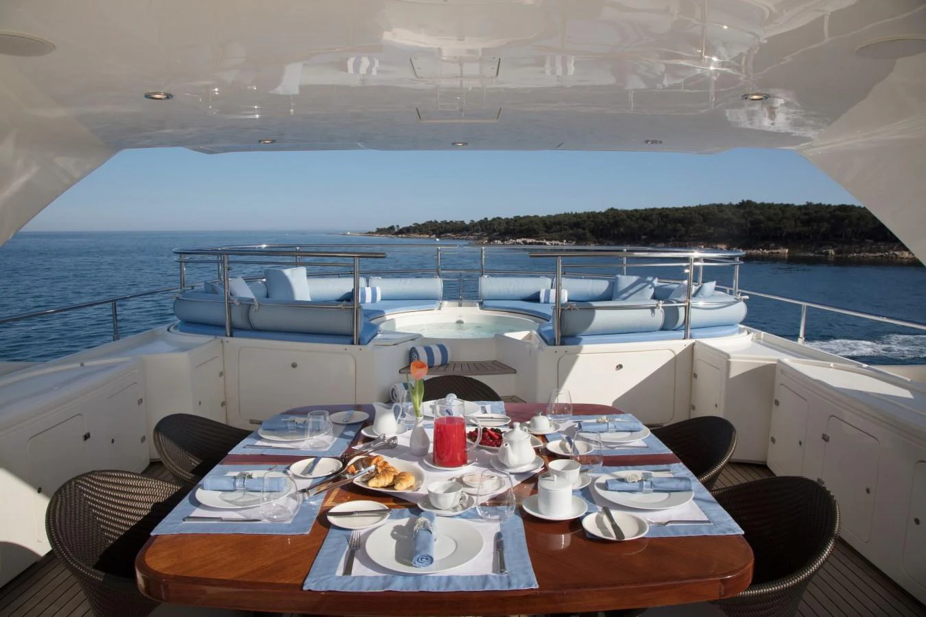 The aft deck features an elegant dining area with a stunning sea view. aboard SIMA Yacht for Sale