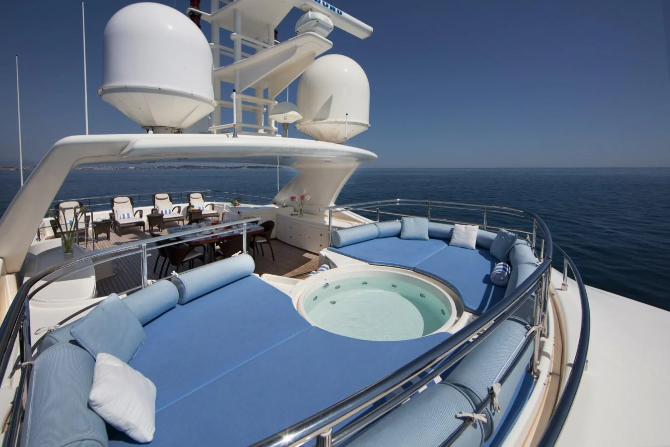 The sundeck features a luxurious jacuzzi surrounded by plush seating, perfect for relaxation. aboard SIMA Yacht for Sale