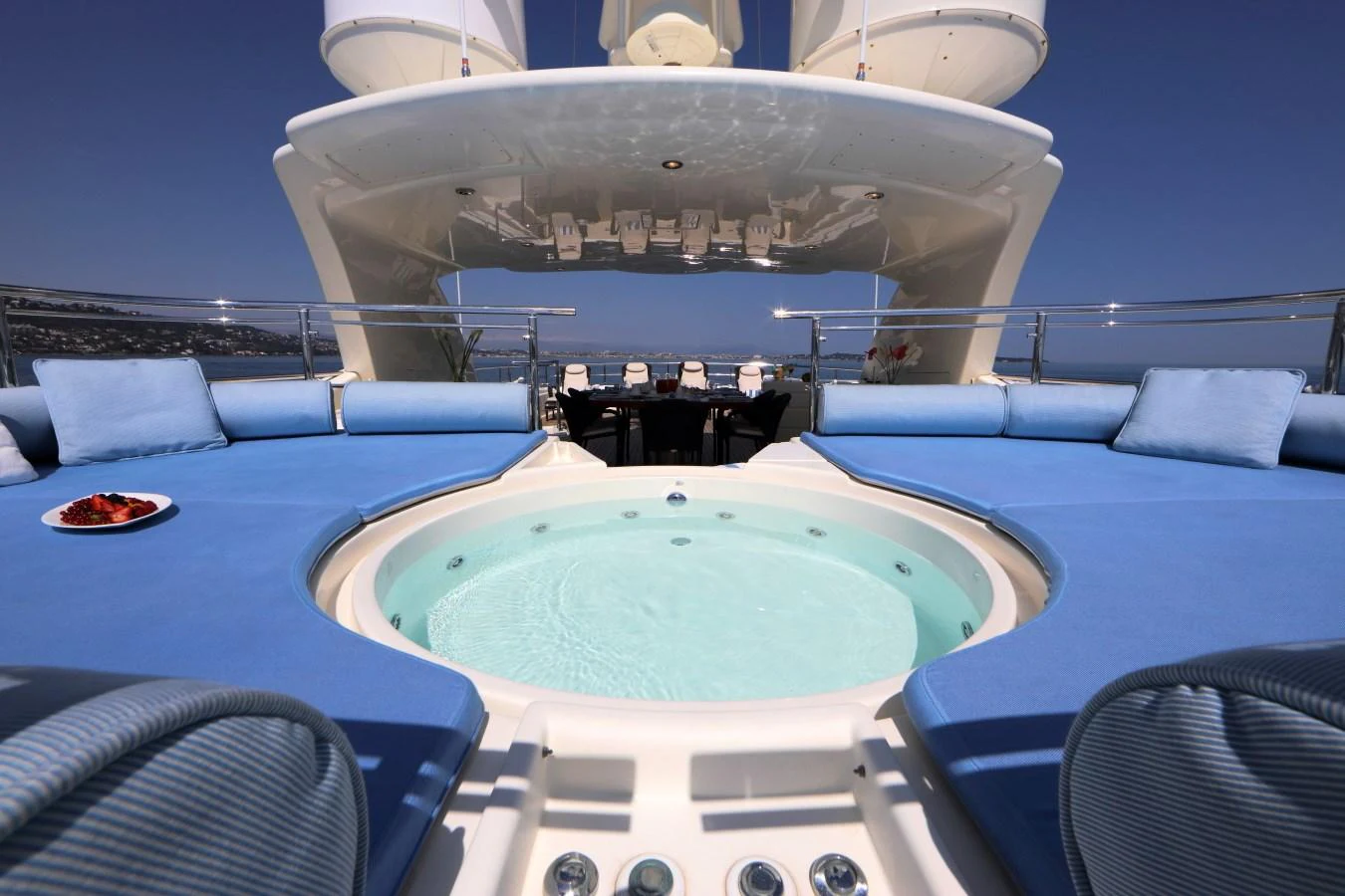 The sundeck features a luxurious jacuzzi surrounded by plush blue seating, perfect for relaxation. aboard SIMA Yacht for Sale