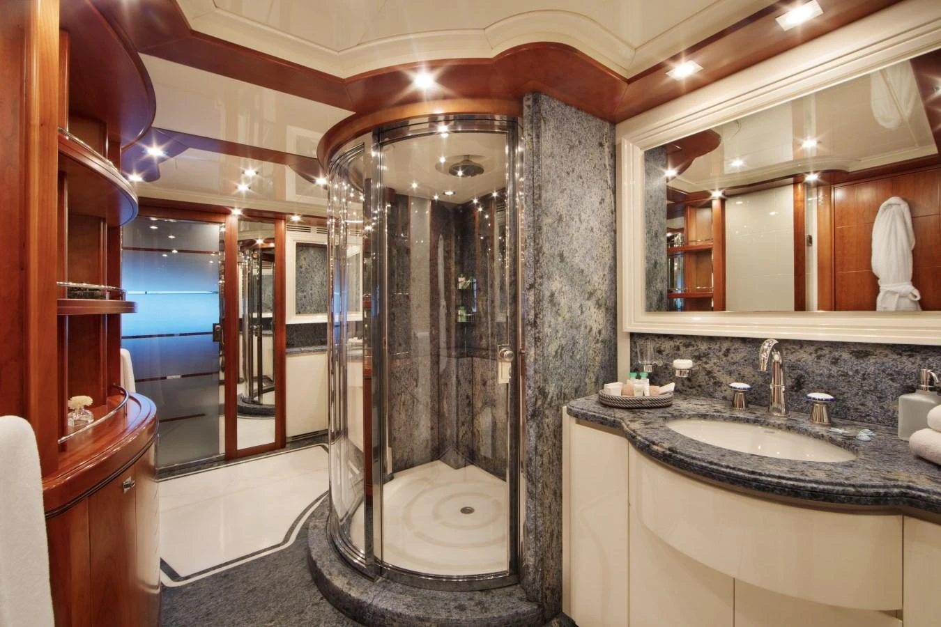 A luxurious yacht bathroom featuring a spacious shower and elegant fixtures. aboard SIMA Yacht for Sale