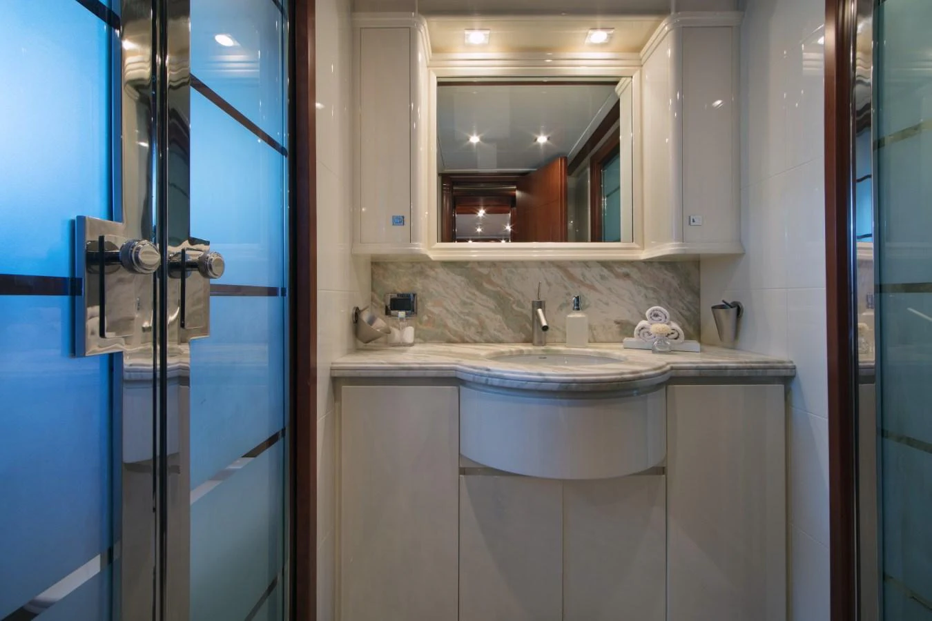 The yacht's bathroom features a sleek, modern design with elegant fixtures and ample lighting. aboard SIMA Yacht for Sale