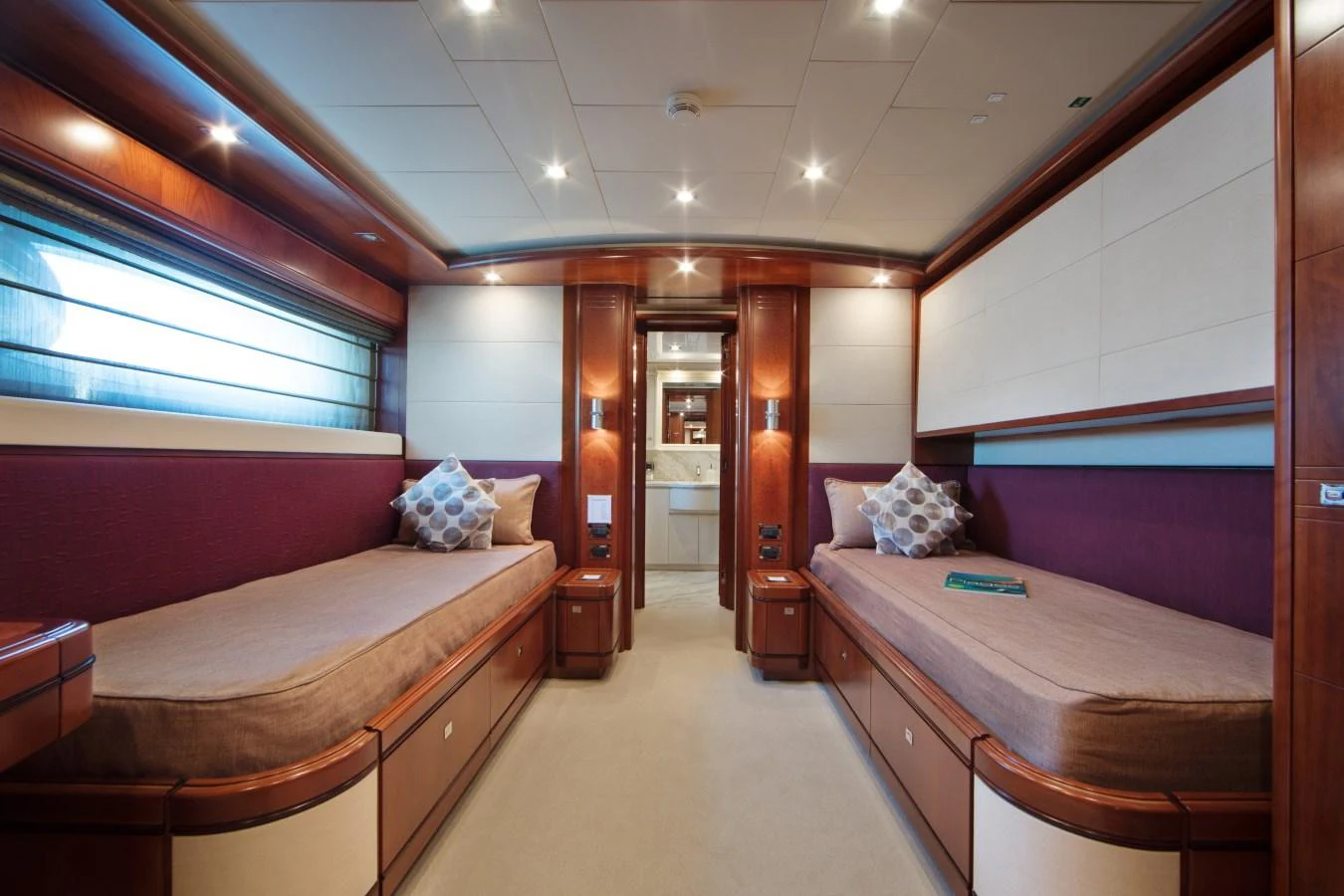 The twin stateroom offers a spacious and elegant sleeping area with two single beds and luxurious finishes. aboard SIMA Yacht for Sale