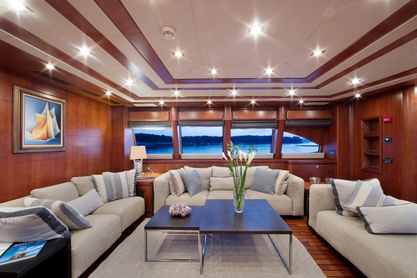 The salon features plush seating, elegant decor, and large windows offering stunning views. aboard SIMA Yacht for Sale