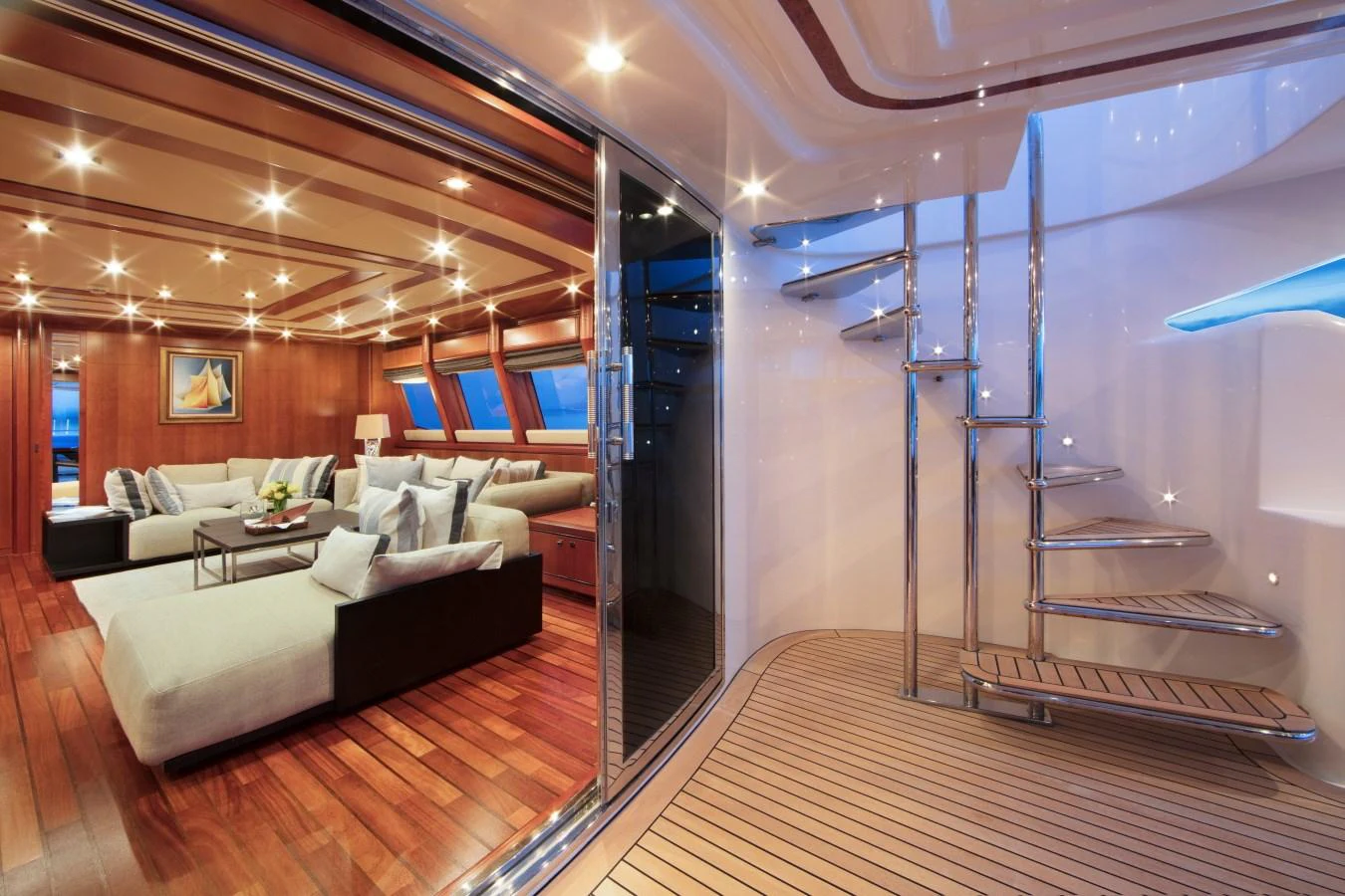 The luxurious salon features elegant seating and modern decor, seamlessly connected to the exterior deck. aboard SIMA Yacht for Sale