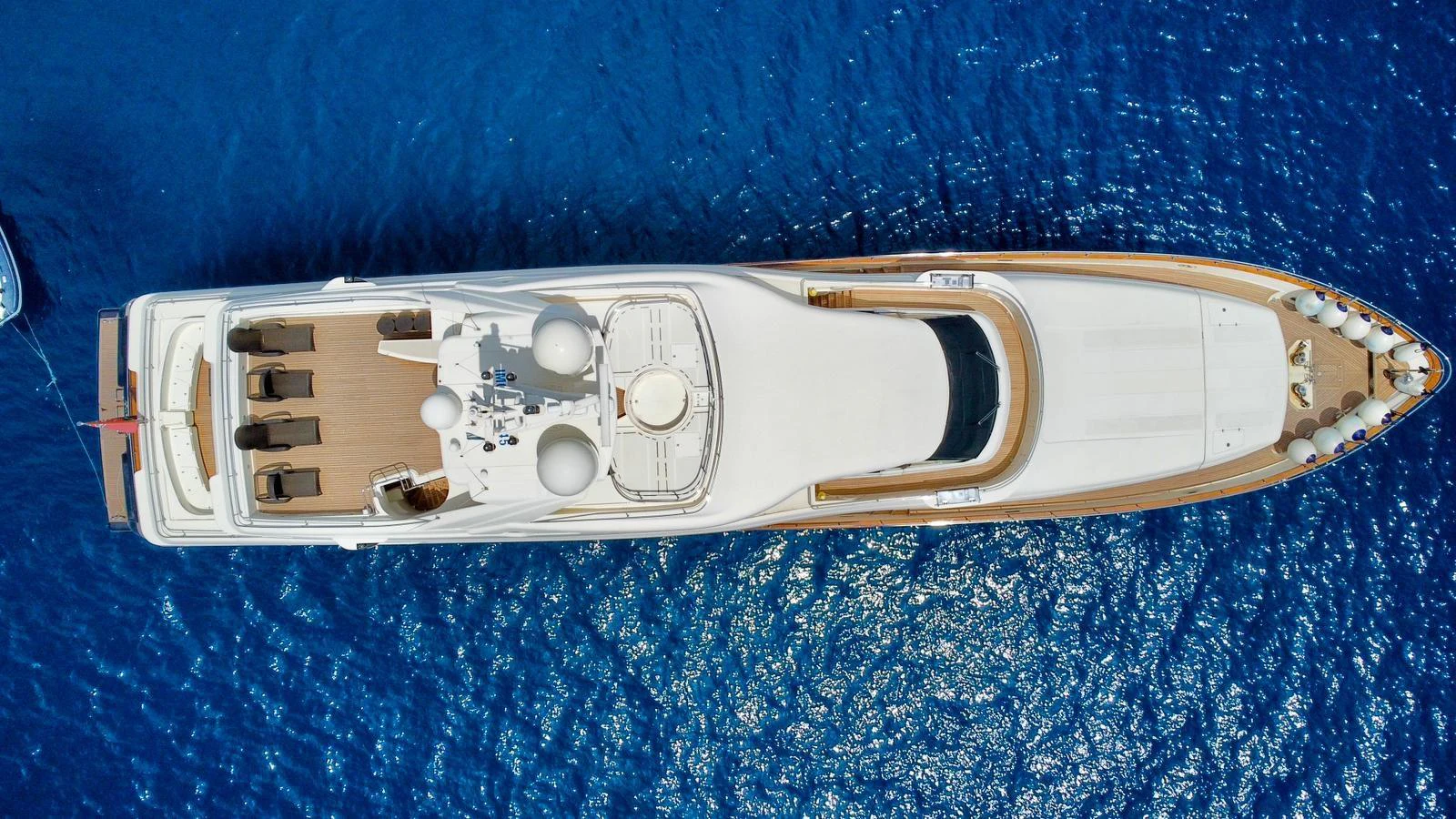 An aerial view of a luxurious yacht cruising on deep blue waters. aboard SIMA Yacht for Sale