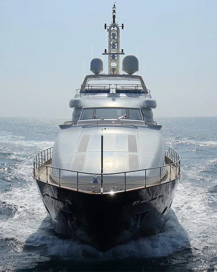 A sleek yacht cuts through the water, showcasing its impressive bow and modern design. aboard SIMA Yacht for Sale