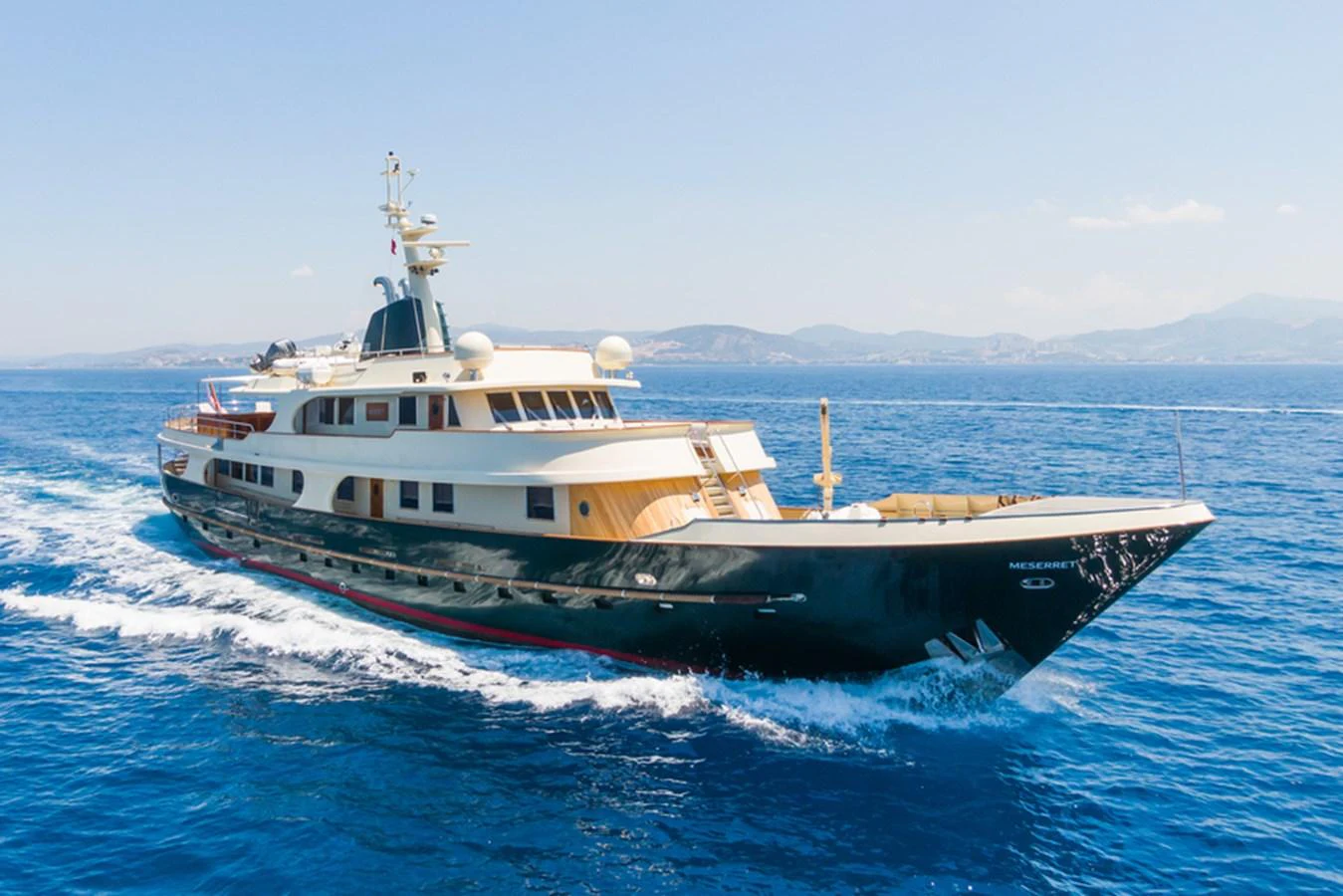 A classic yacht cruises through the open sea, showcasing its elegant design and luxurious amenities. aboard MESERRET Yacht for Sale