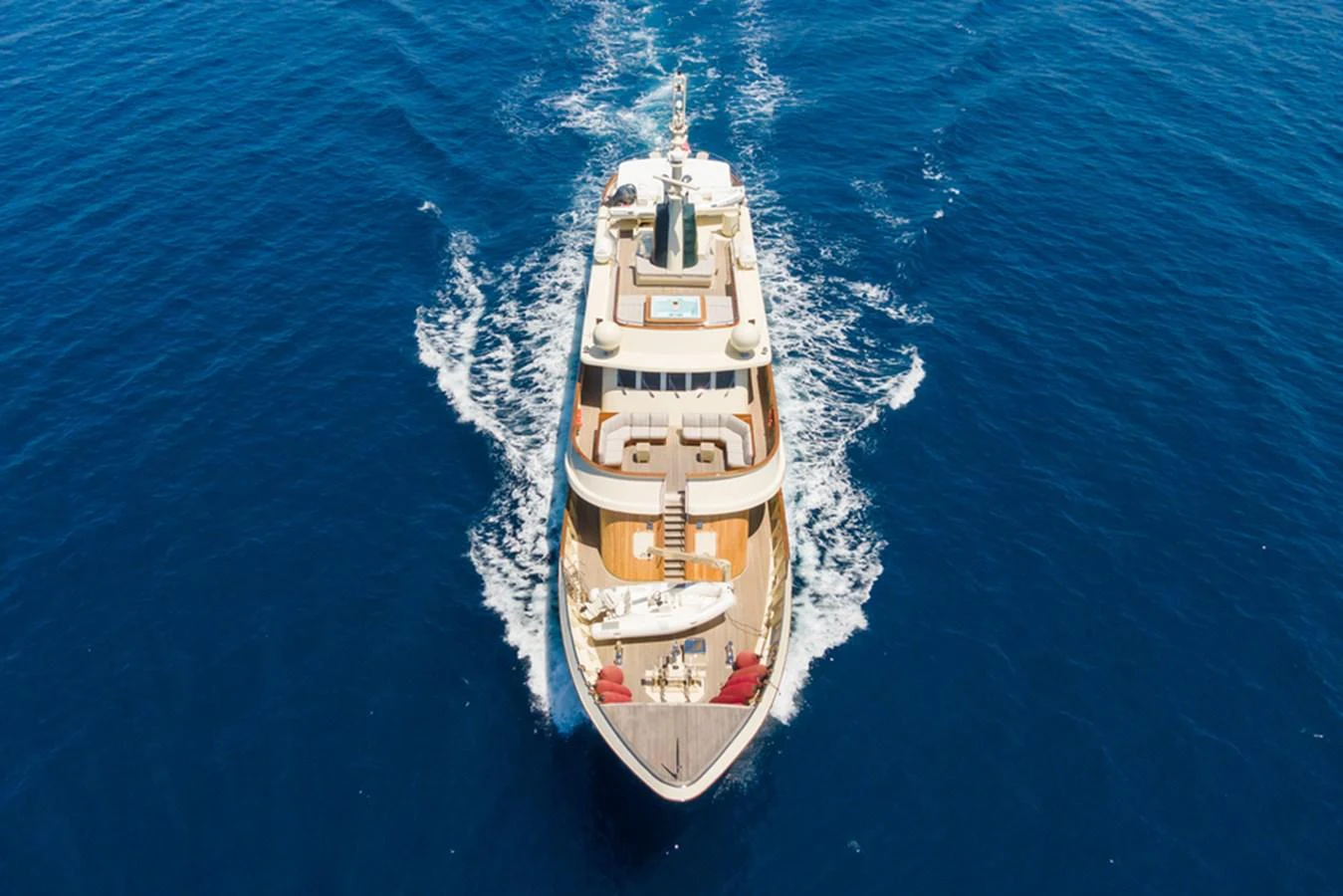 A luxurious yacht cruises through the open blue sea, showcasing its elegant design and spacious decks. aboard MESERRET Yacht for Sale