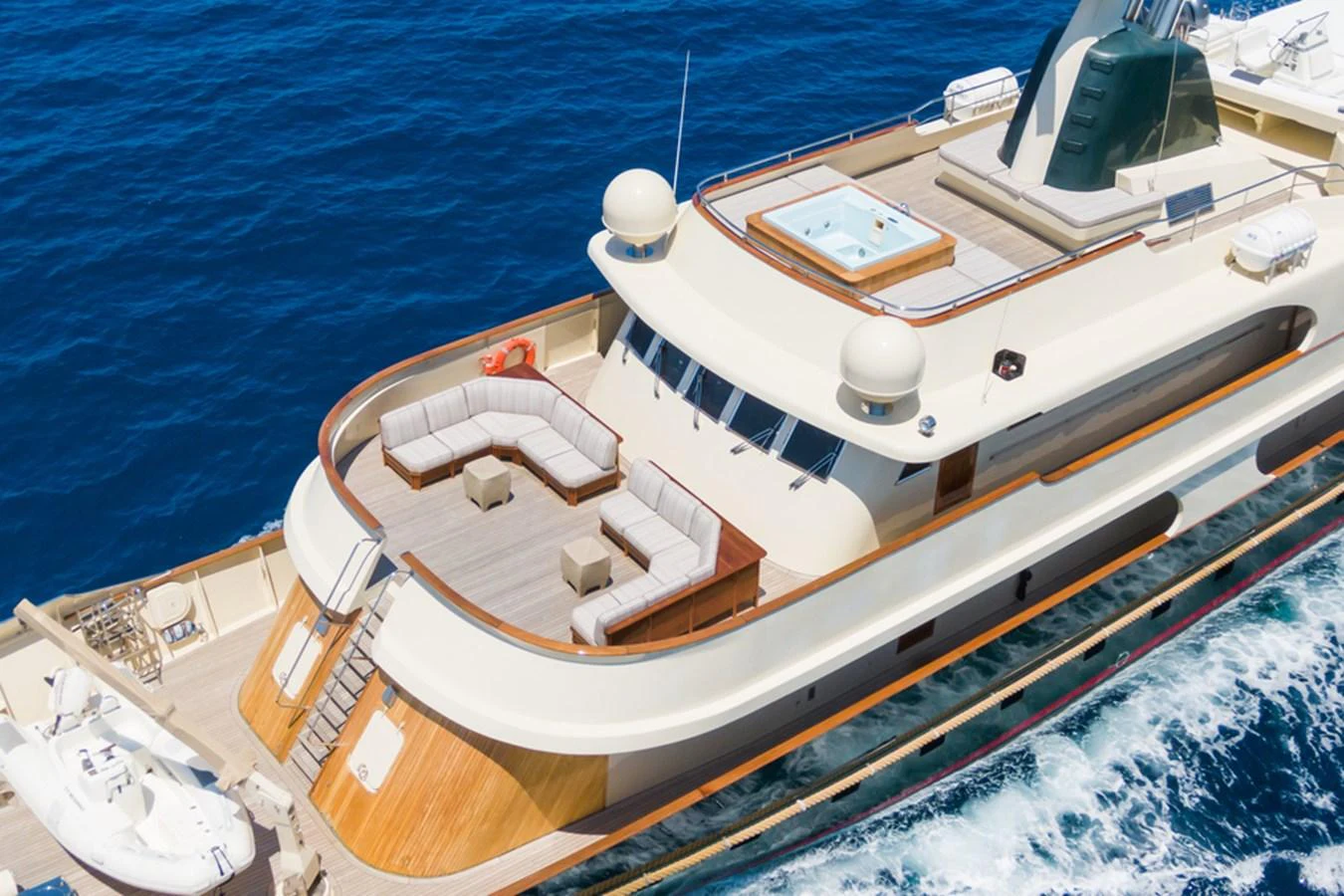 A luxurious yacht cruising on the open sea, showcasing its spacious aft deck and inviting seating area. aboard MESERRET Yacht for Sale