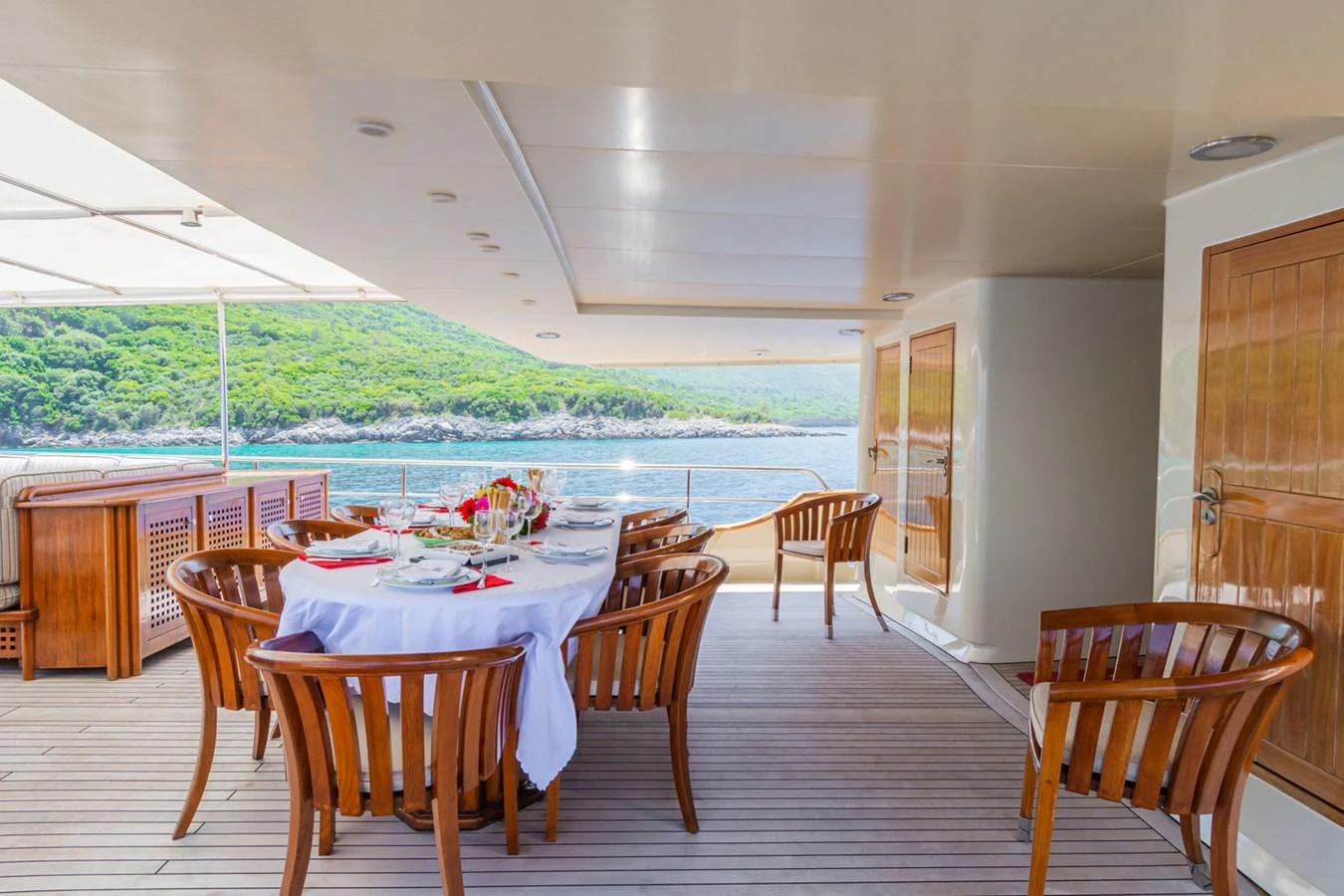The aft deck features an elegant dining area with a stunning view of the surrounding waters. aboard MESERRET Yacht for Sale