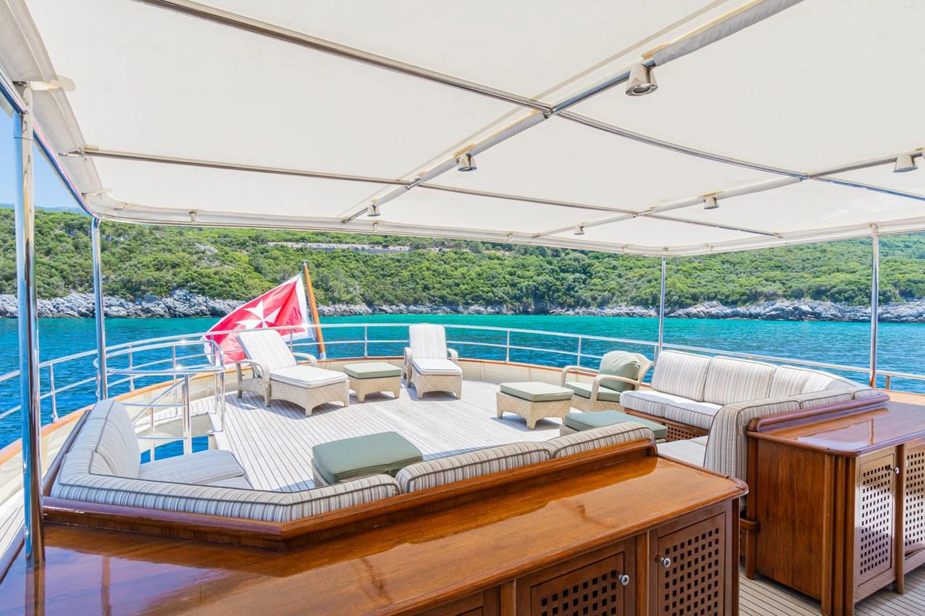 The aft deck offers a spacious and shaded lounging area with comfortable seating and scenic views. aboard MESERRET Yacht for Sale