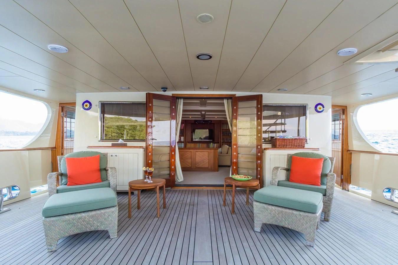 The aft deck features comfortable seating with a view into the interior salon. aboard MESERRET Yacht for Sale