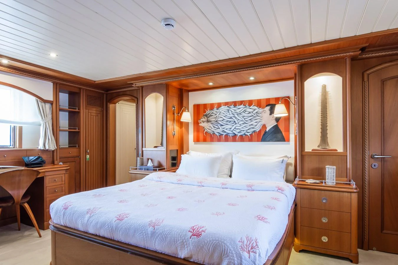 The master stateroom features a luxurious bed with elegant wood paneling and ample storage space. aboard MESERRET Yacht for Sale