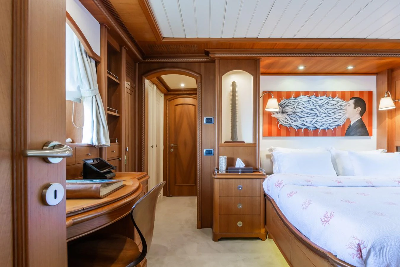 A luxurious stateroom featuring a comfortable bed, wooden furnishings, and elegant decor. aboard MESERRET Yacht for Sale
