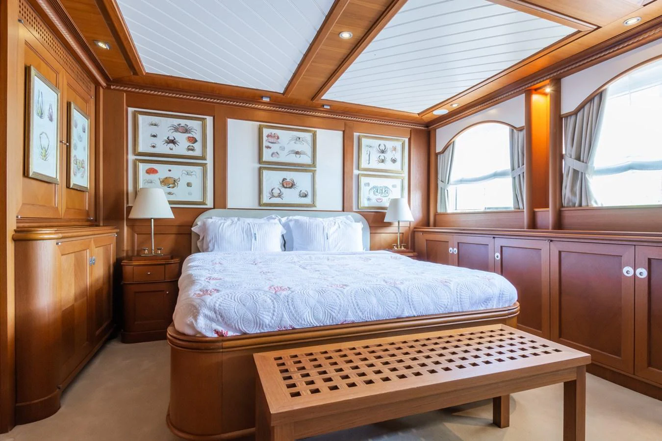 The master stateroom features elegant wood paneling, a large bed, and ample natural light. aboard MESERRET Yacht for Sale