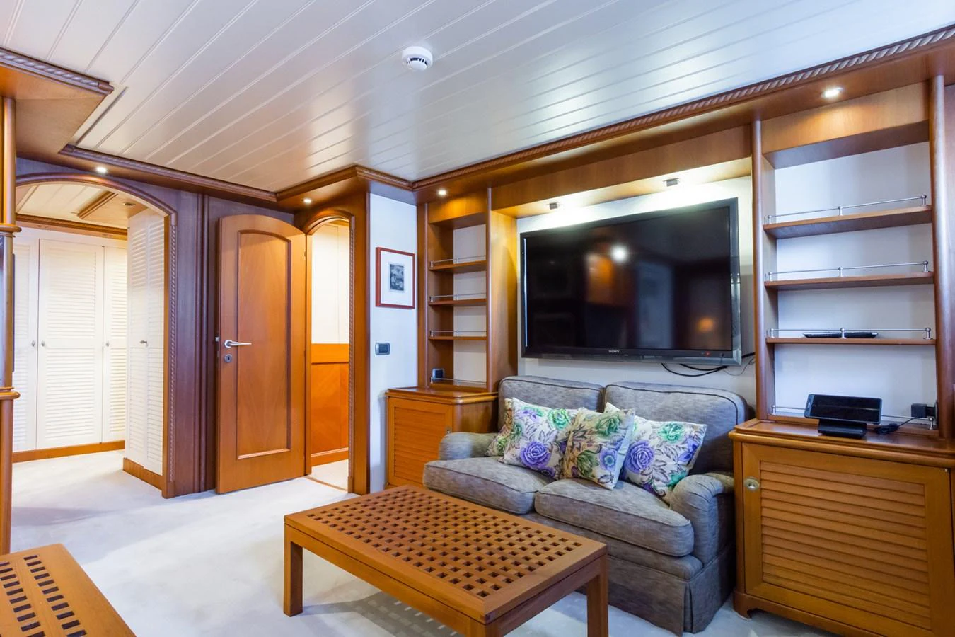 The salon features a cozy seating area with a large television and elegant wooden cabinetry. aboard MESERRET Yacht for Sale