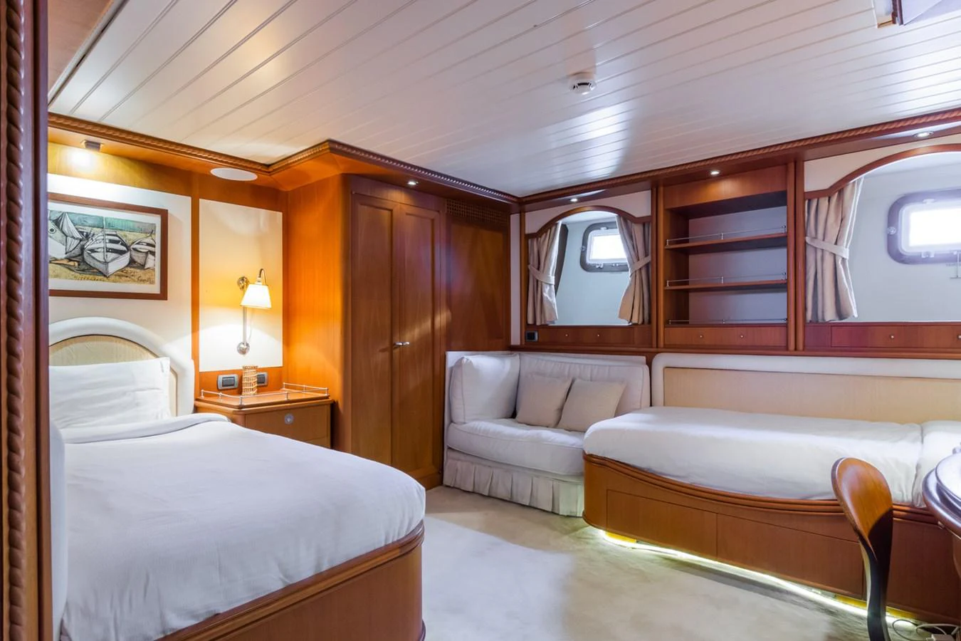 The guest stateroom features cozy twin beds, a comfortable sofa, and elegant wooden cabinetry. aboard MESERRET Yacht for Sale