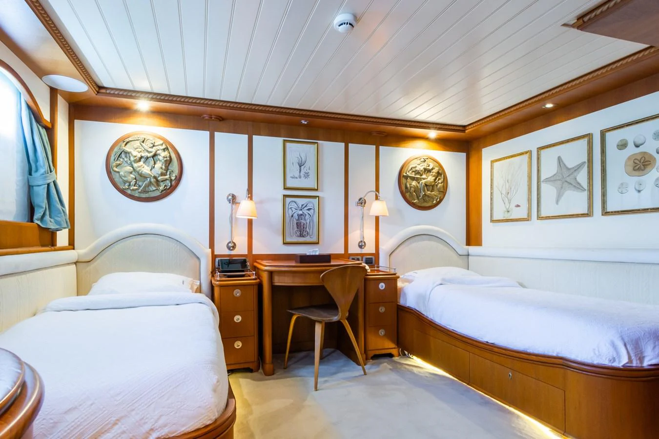 A cozy twin stateroom featuring two single beds and elegant wooden furnishings. aboard MESERRET Yacht for Sale