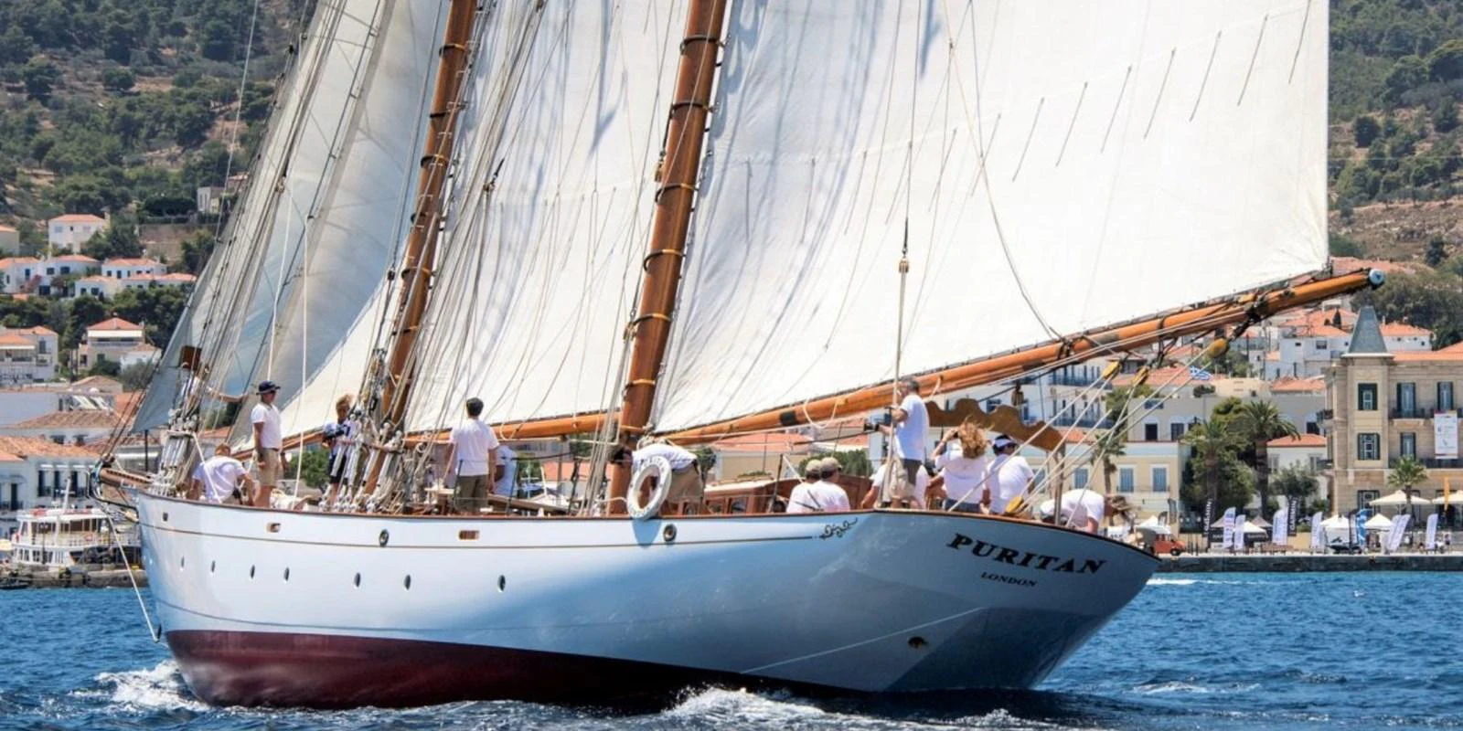 A classic sailing yacht glides gracefully on the water, showcasing its elegant design and traditional rigging. aboard PURITAN Yacht for Sale