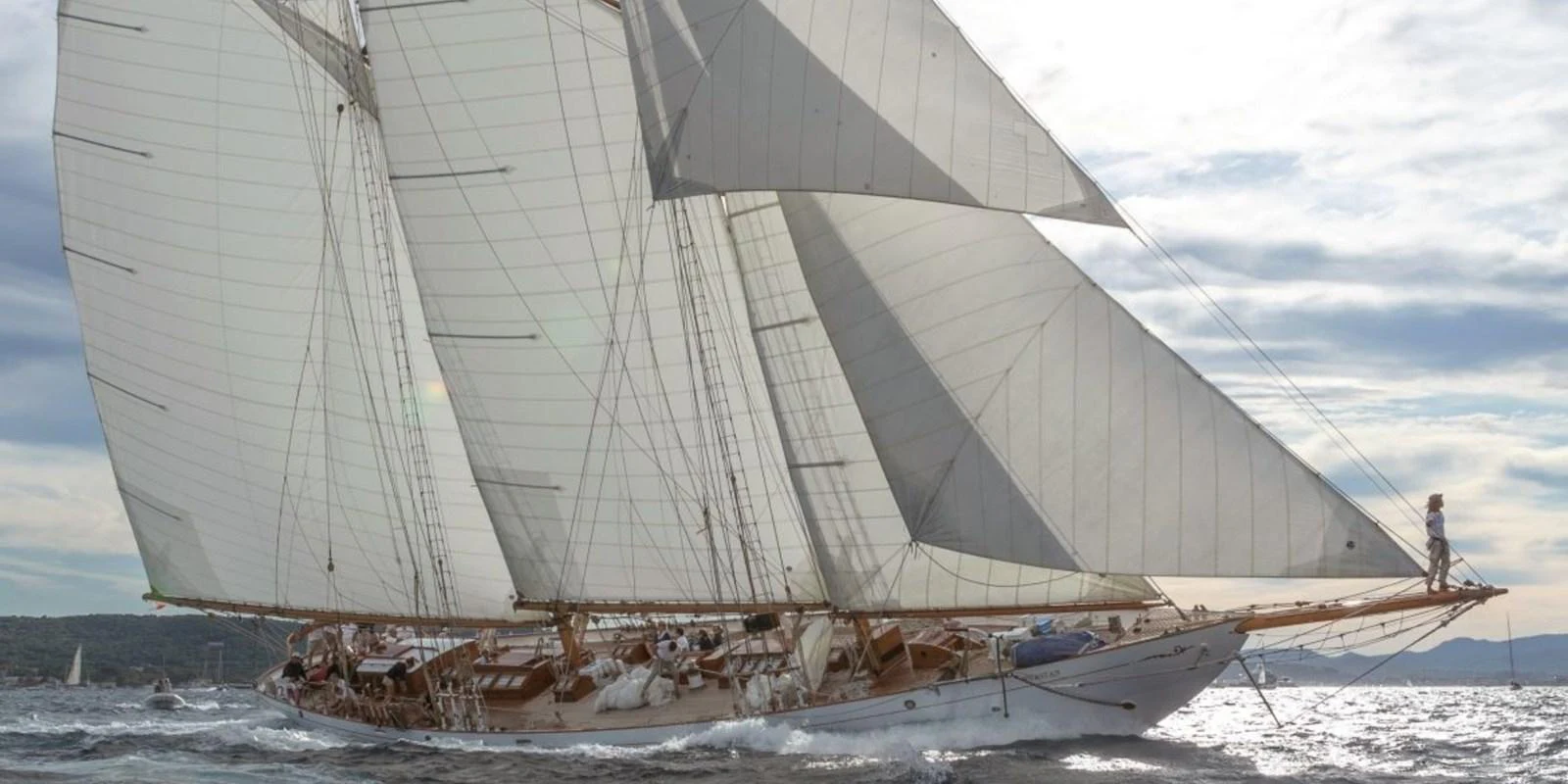 A classic sailing yacht gracefully glides through the water with its sails fully unfurled. aboard PURITAN Yacht for Sale