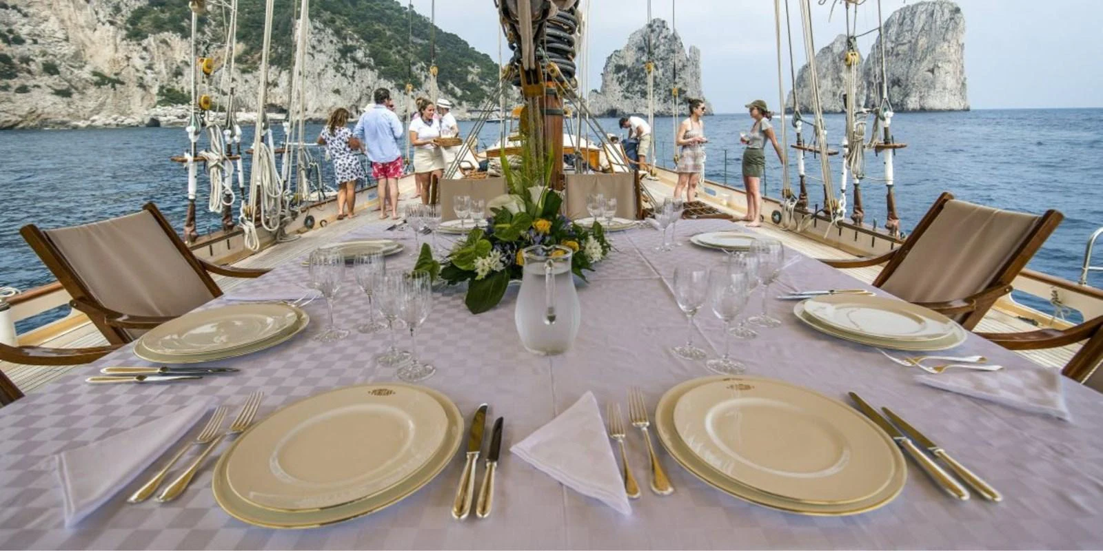 An elegant outdoor dining area on the yacht, set with fine tableware and surrounded by scenic views. aboard PURITAN Yacht for Sale