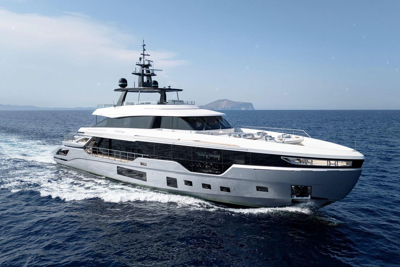 A sleek and modern yacht cruises through the open sea, showcasing its elegant design and luxurious amenities. aboard TAMANYA Yacht for Sale