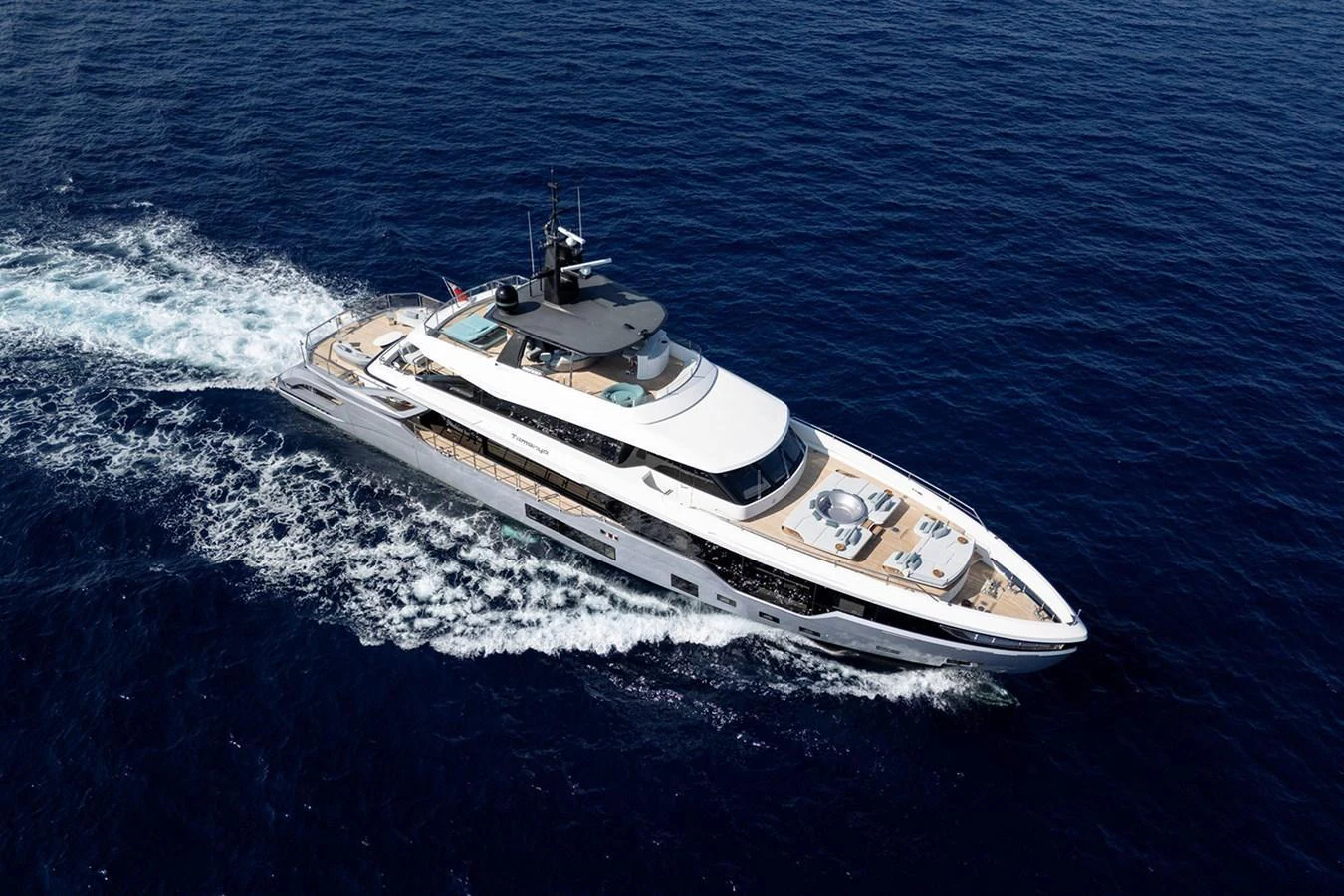 A sleek and modern yacht cruising through deep blue waters. aboard TAMANYA Yacht for Sale