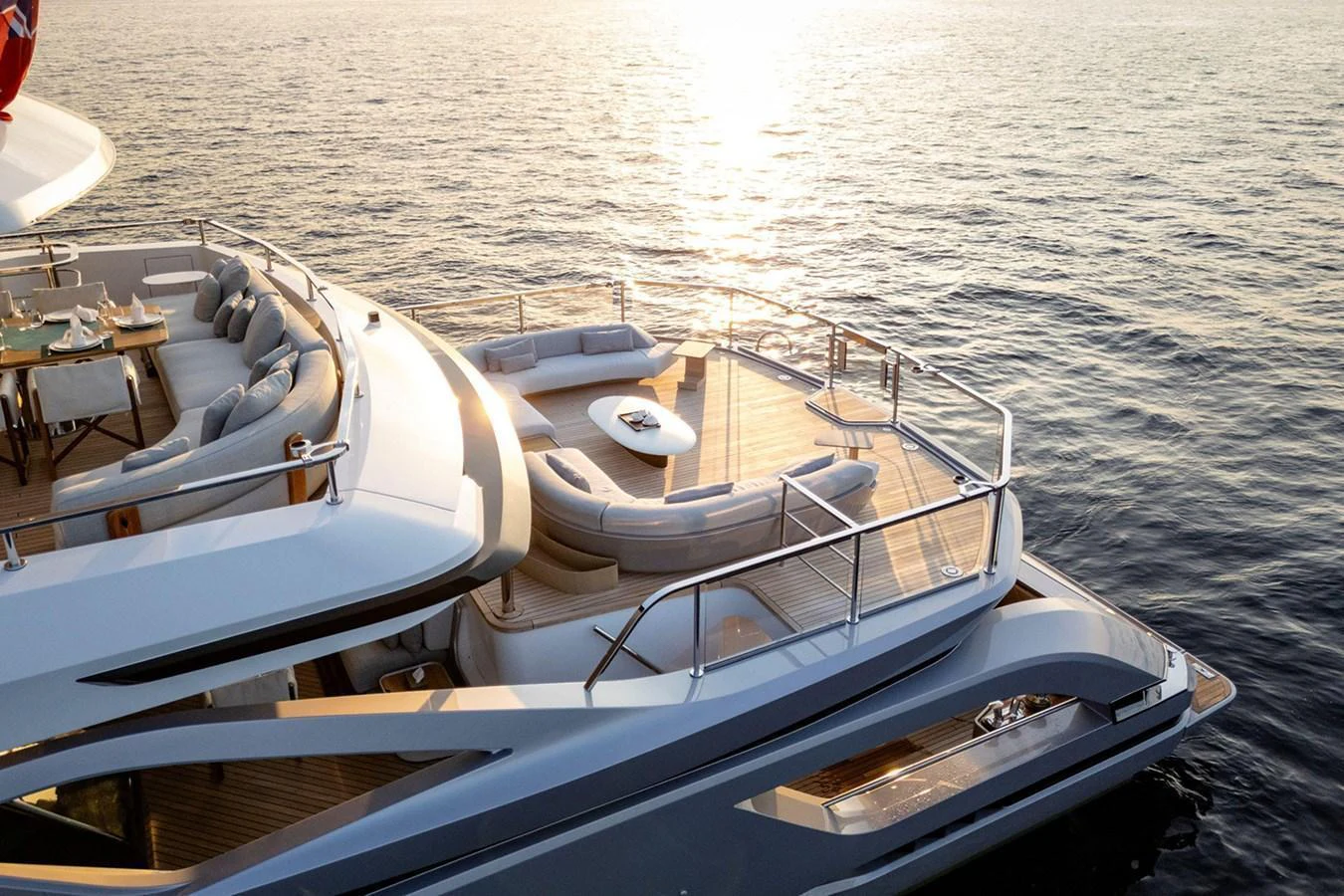 The yacht's aft deck features luxurious seating areas and a dining space, perfect for enjoying the sunset over the water. aboard TAMANYA Yacht for Sale