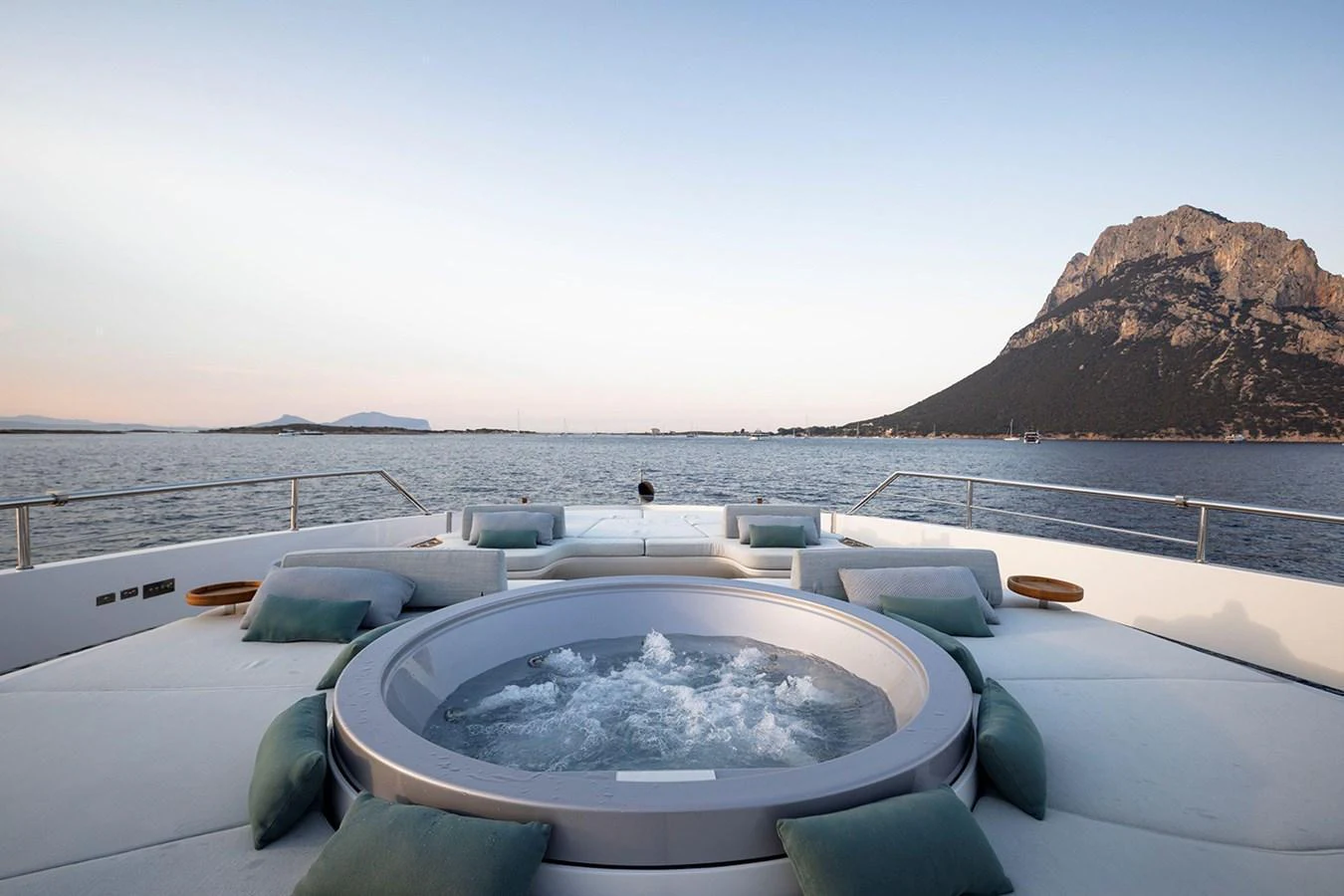 The sundeck features a luxurious jacuzzi surrounded by plush seating, offering stunning views of the sea and mountains. aboard TAMANYA Yacht for Sale