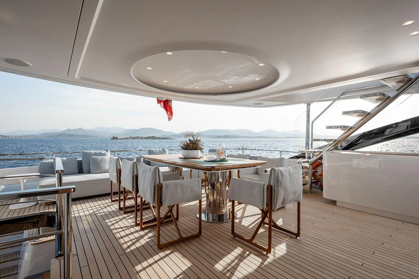The aft deck features an elegant dining area with a stunning ocean view. aboard TAMANYA Yacht for Sale
