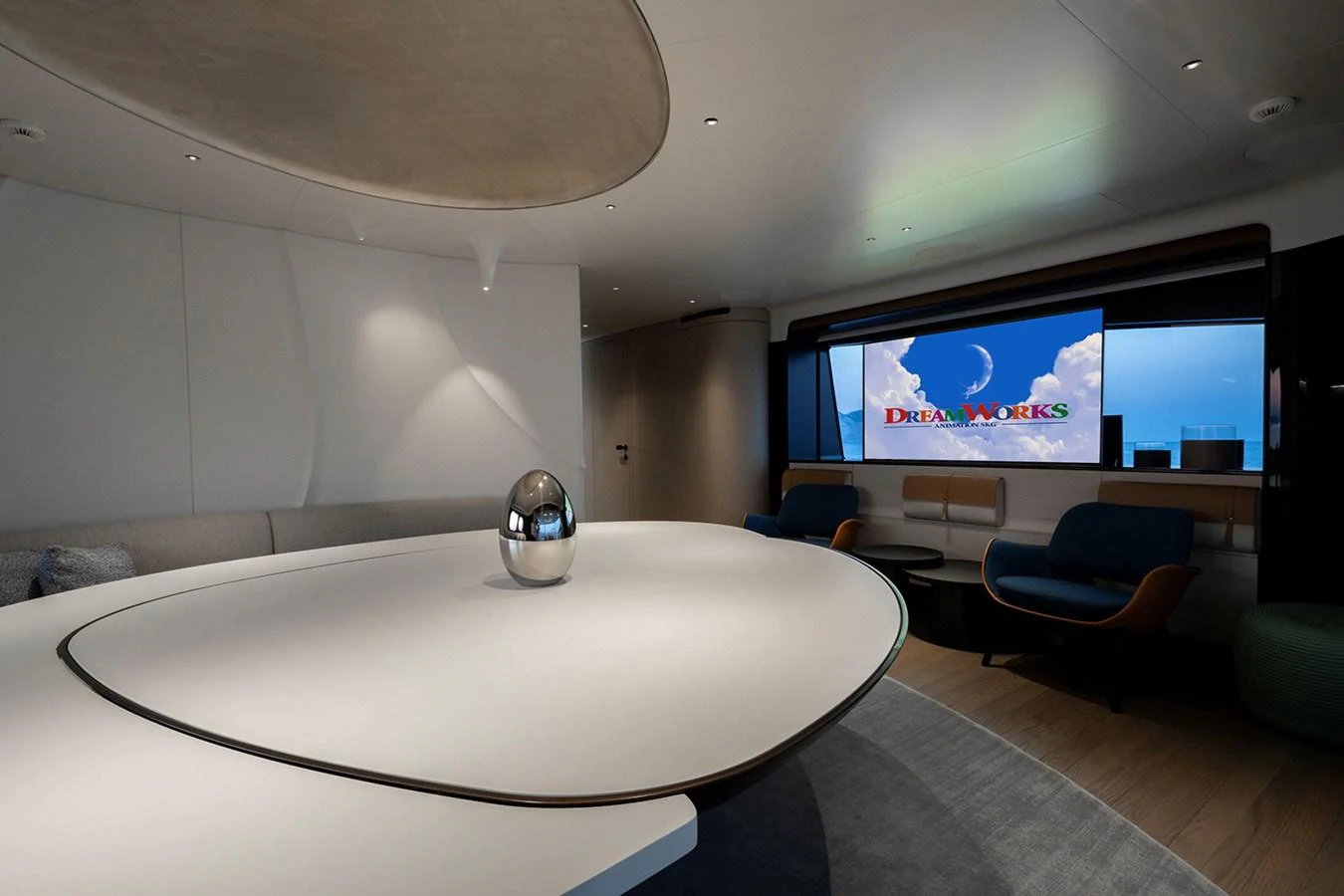 The yacht's interior features a modern and elegant lounge area with a large table and comfortable seating. aboard TAMANYA Yacht for Sale