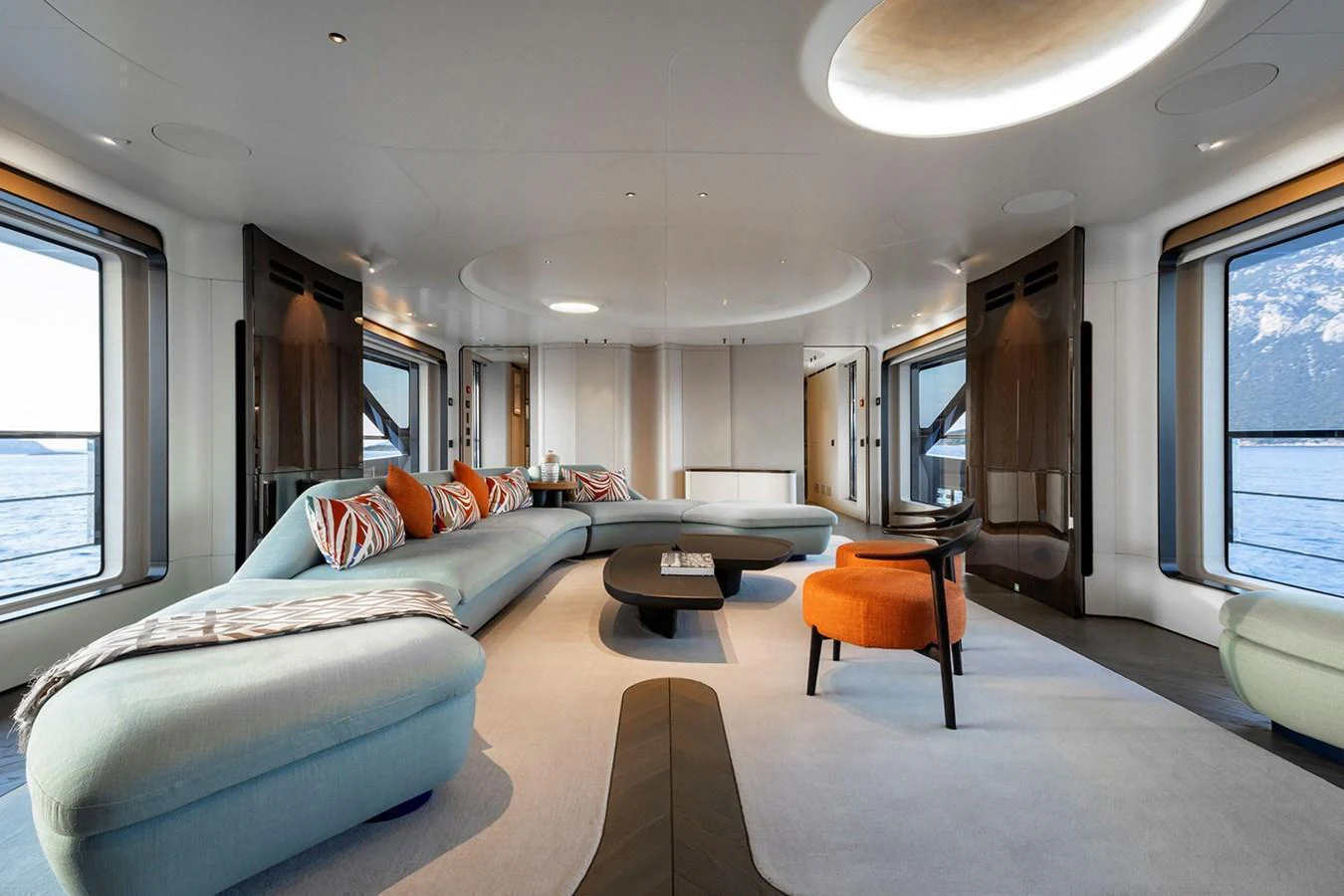 The salon features a spacious and modern design with large windows offering stunning sea views. aboard TAMANYA Yacht for Sale