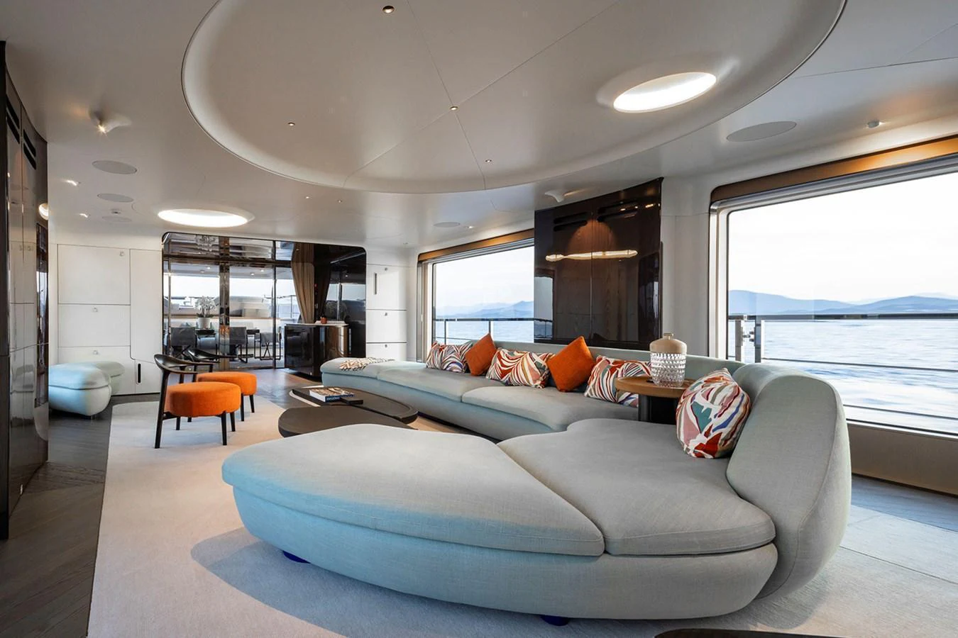 The yacht's salon features a spacious and modern seating area with large windows offering stunning ocean views. aboard TAMANYA Yacht for Sale