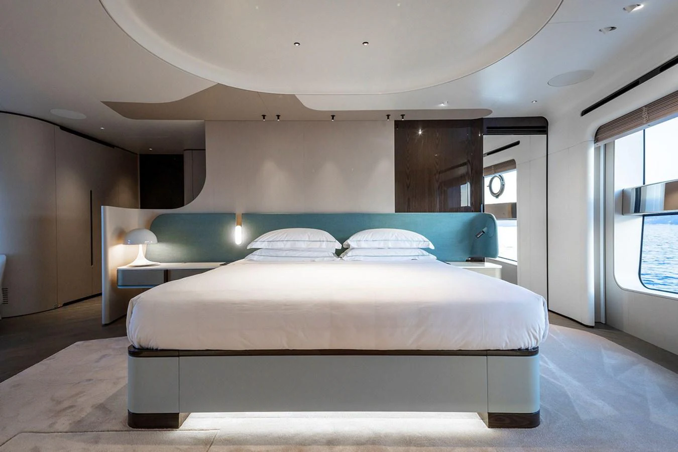 The master stateroom features a spacious bed with modern, elegant decor and ample natural light. aboard TAMANYA Yacht for Sale