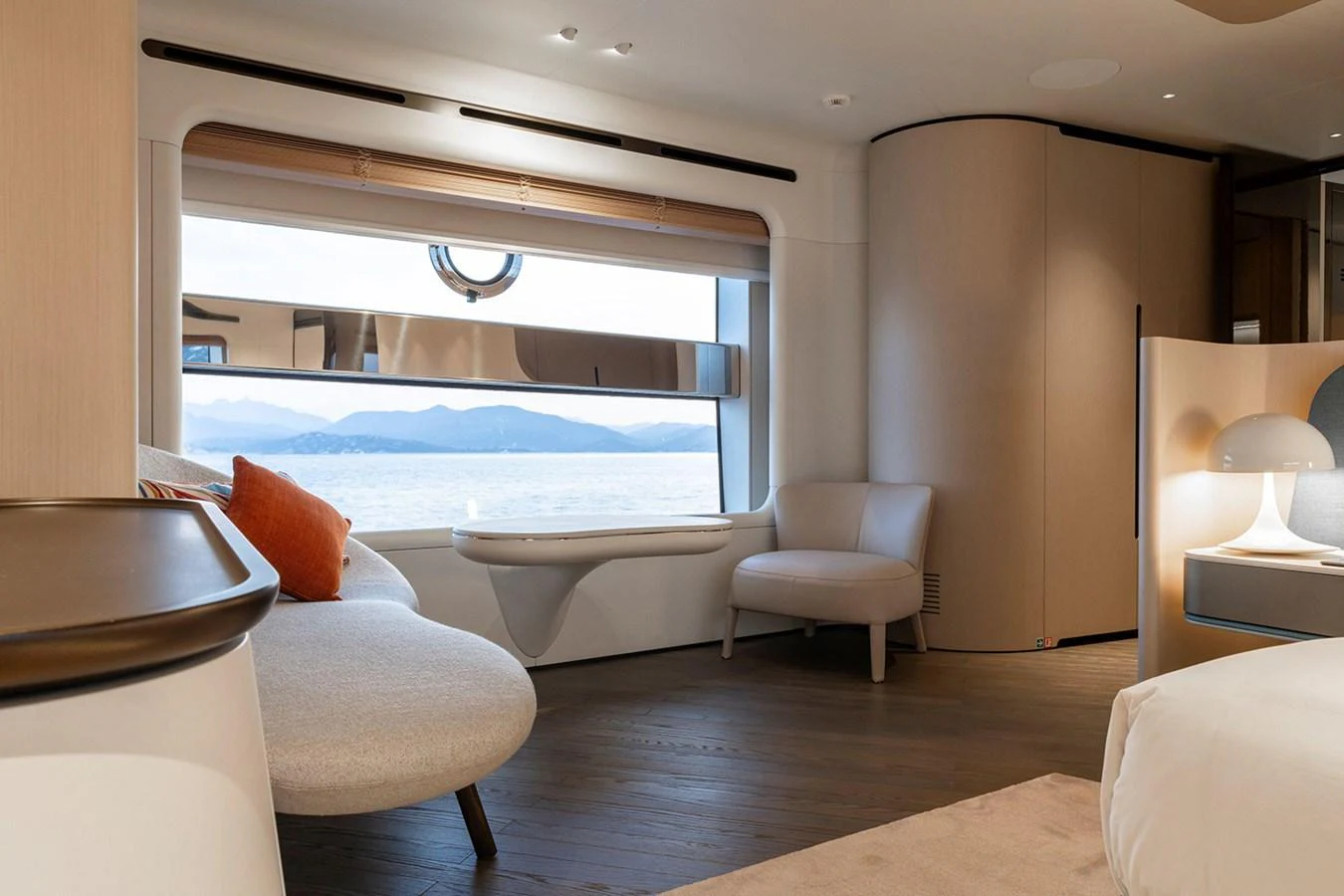A luxurious stateroom with a large window offering a stunning sea view. aboard TAMANYA Yacht for Sale