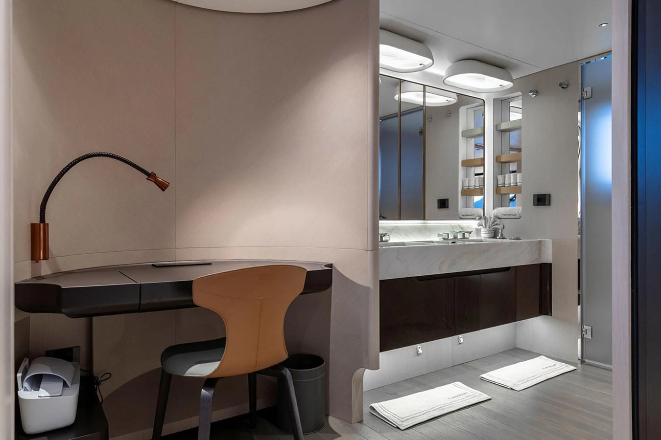 A sleek and modern bathroom with a vanity and a small desk area. aboard TAMANYA Yacht for Sale