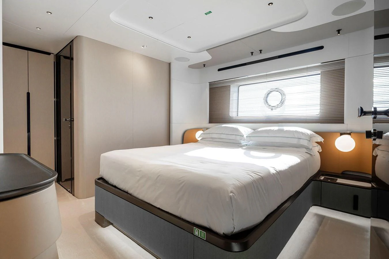 The stateroom features a modern design with a comfortable bed and ample natural light. aboard TAMANYA Yacht for Sale