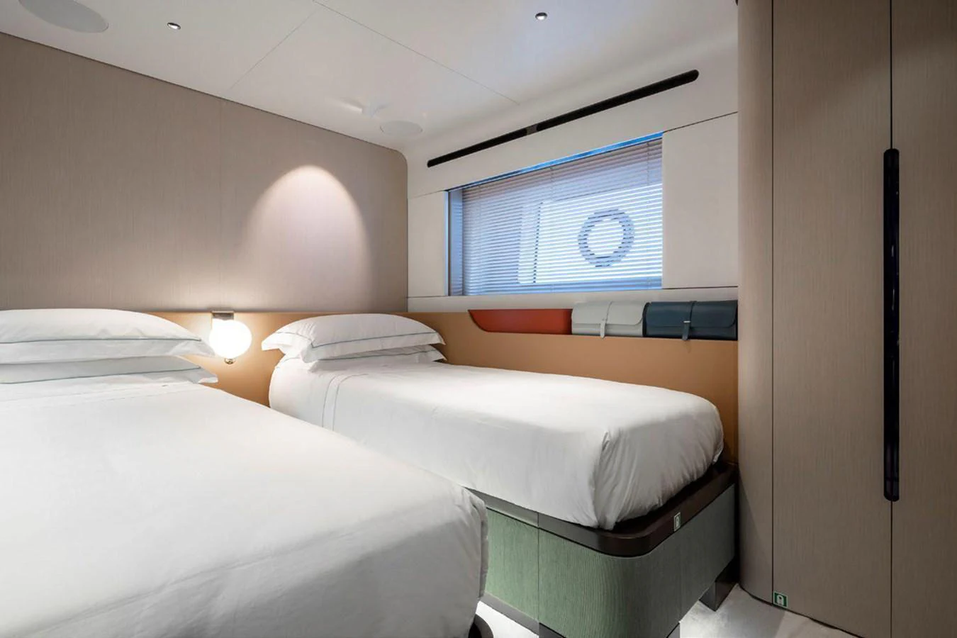 The twin stateroom offers a serene and comfortable sleeping area with modern design elements. aboard TAMANYA Yacht for Sale