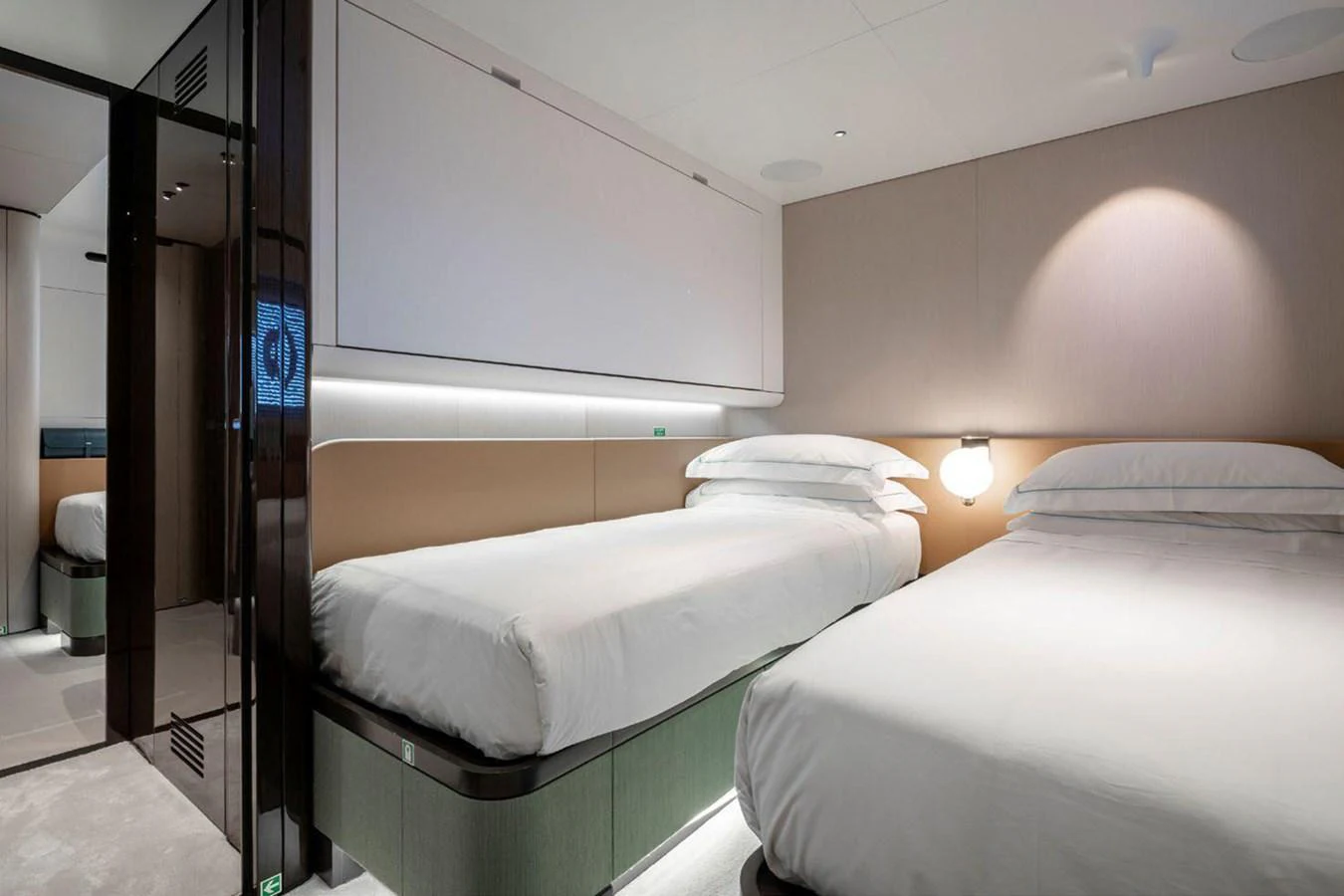 The twin stateroom offers a serene and comfortable sleeping area with modern design elements. aboard TAMANYA Yacht for Sale