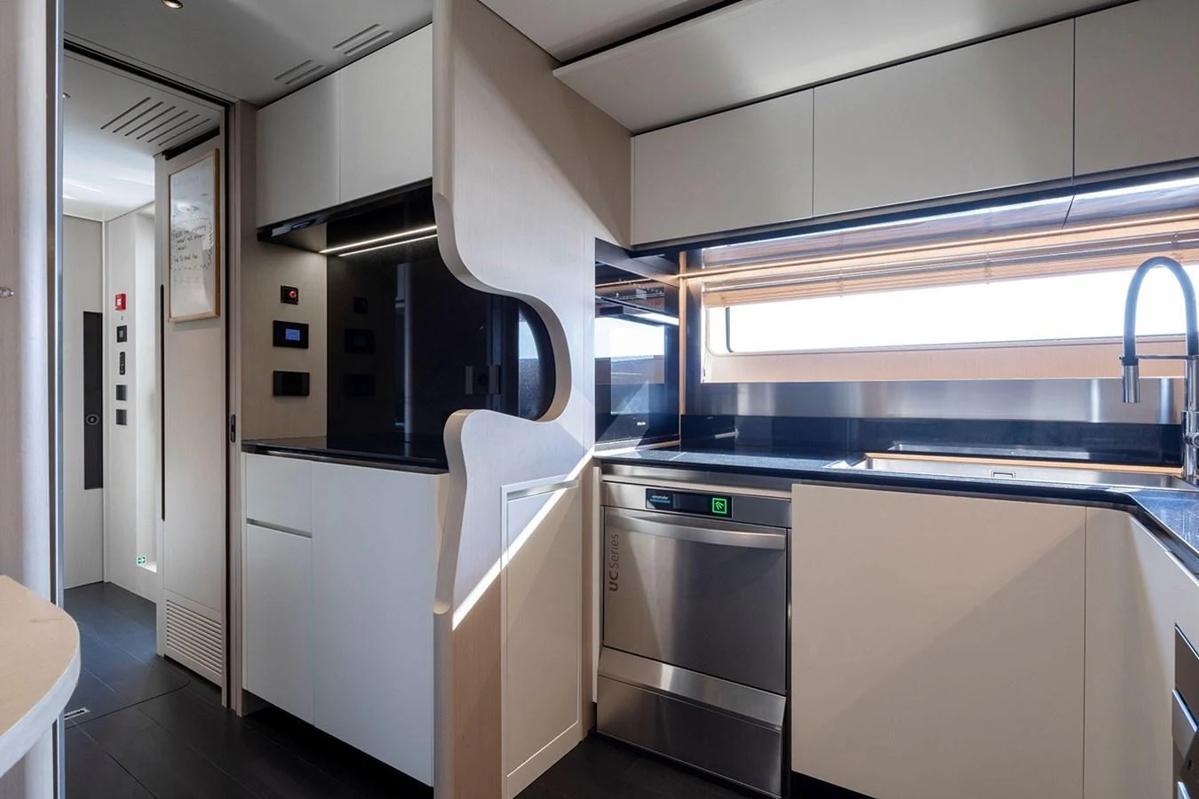 The modern galley features sleek cabinetry, high-end appliances, and ample counter space. aboard TAMANYA Yacht for Sale