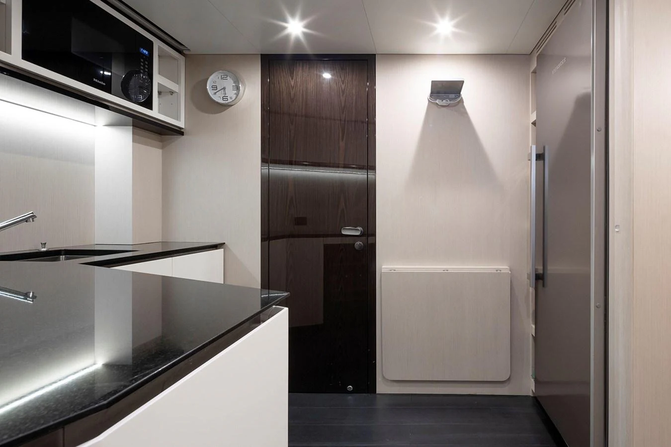 The yacht's galley features modern appliances and sleek finishes, creating a stylish and functional space. aboard TAMANYA Yacht for Sale