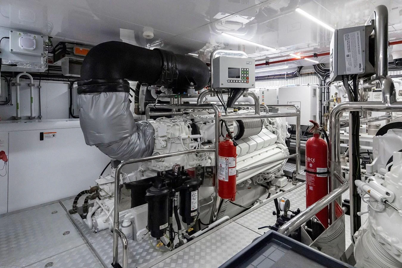 The image showcases the well-maintained engine room of the yacht, featuring advanced machinery and safety equipment. aboard TAMANYA Yacht for Sale