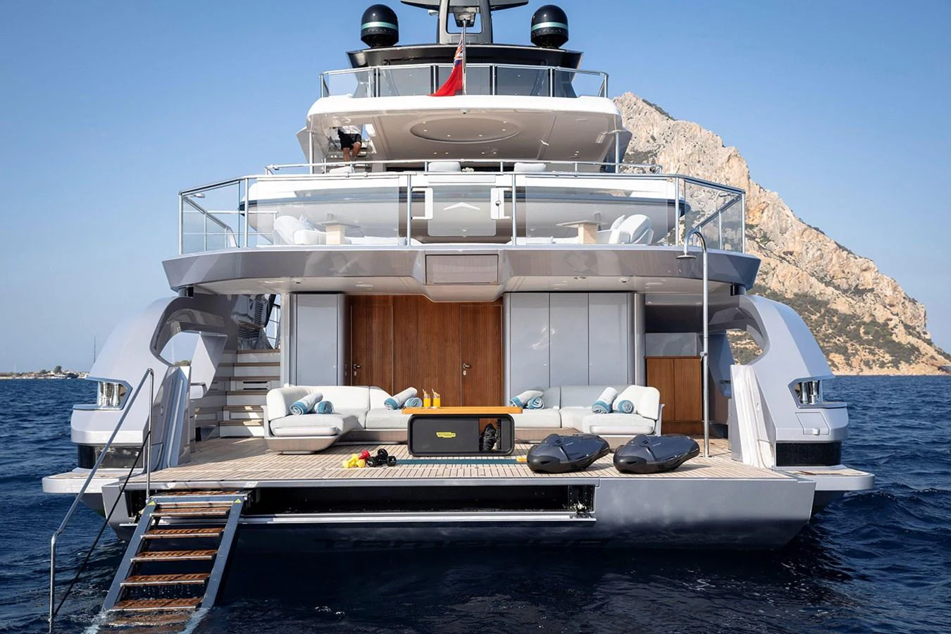 The yacht's aft deck features a luxurious lounging area with direct access to the water. aboard TAMANYA Yacht for Sale