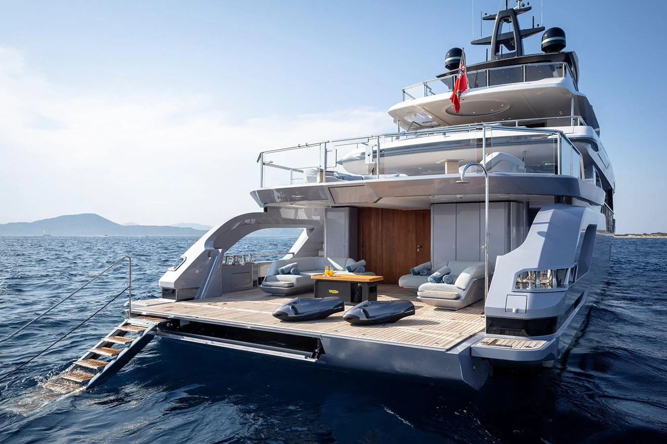 The yacht's aft deck features a spacious lounging area with direct access to the water. aboard TAMANYA Yacht for Sale