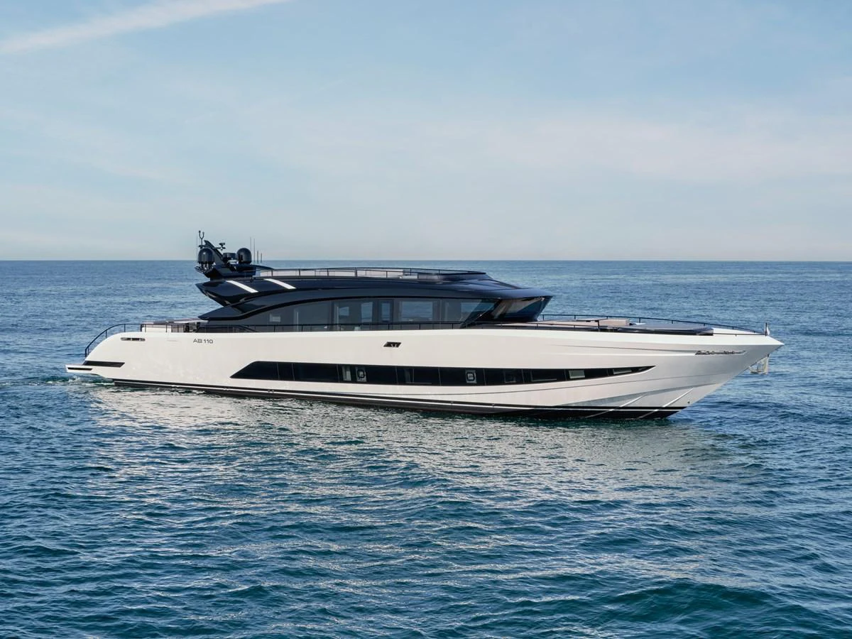 A sleek and modern yacht cruising on calm waters under a clear sky. aboard AB 110 Yacht for Sale