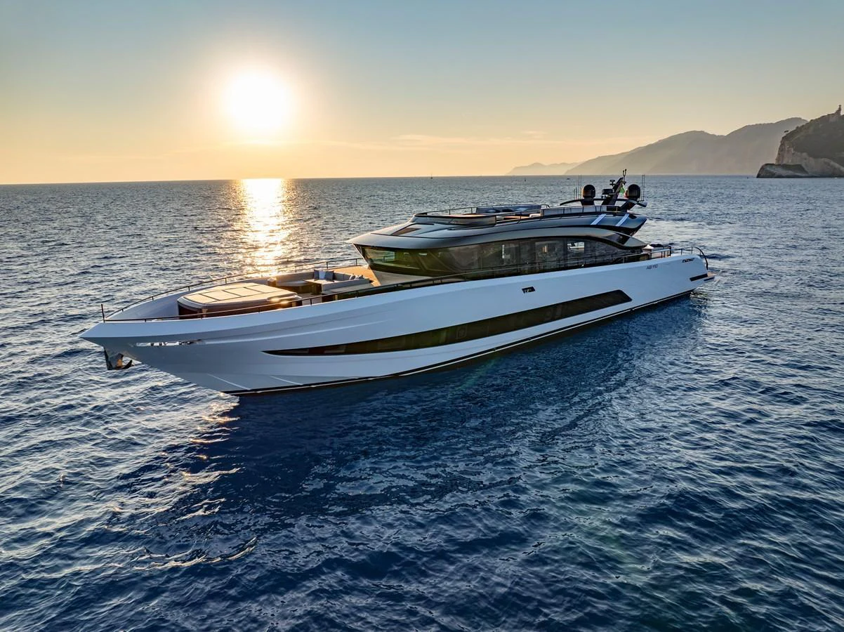A sleek and modern yacht cruising on calm waters at sunset. aboard AB 110 Yacht for Sale