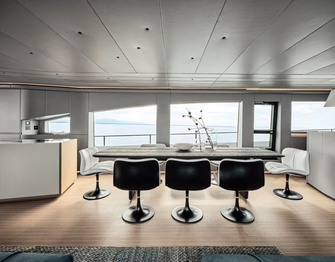 The yacht's dining area features a sleek, modern design with panoramic ocean views. aboard AB 110 Yacht for Sale