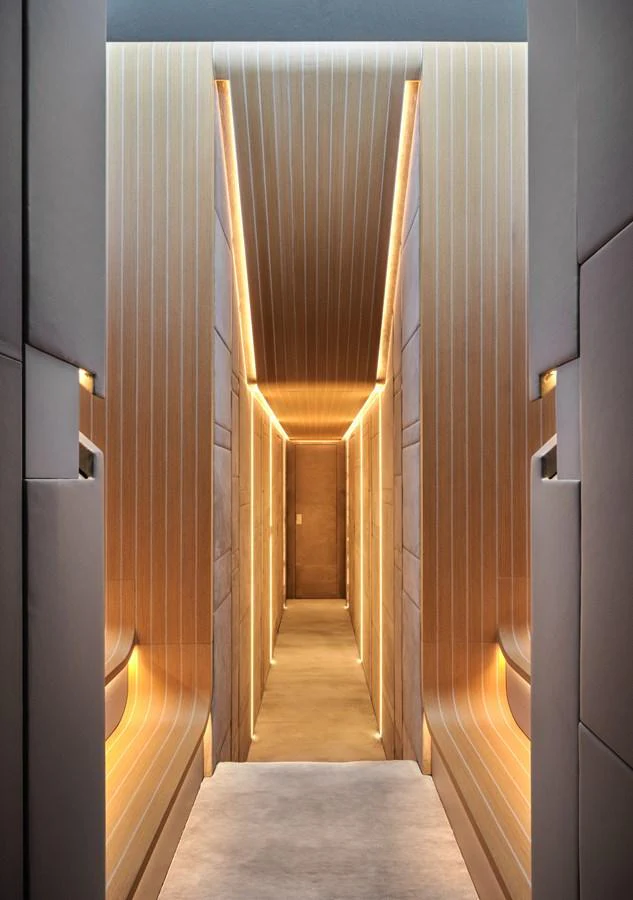 A sleek and modern hallway with ambient lighting and elegant wood paneling. aboard AB 110 Yacht for Sale